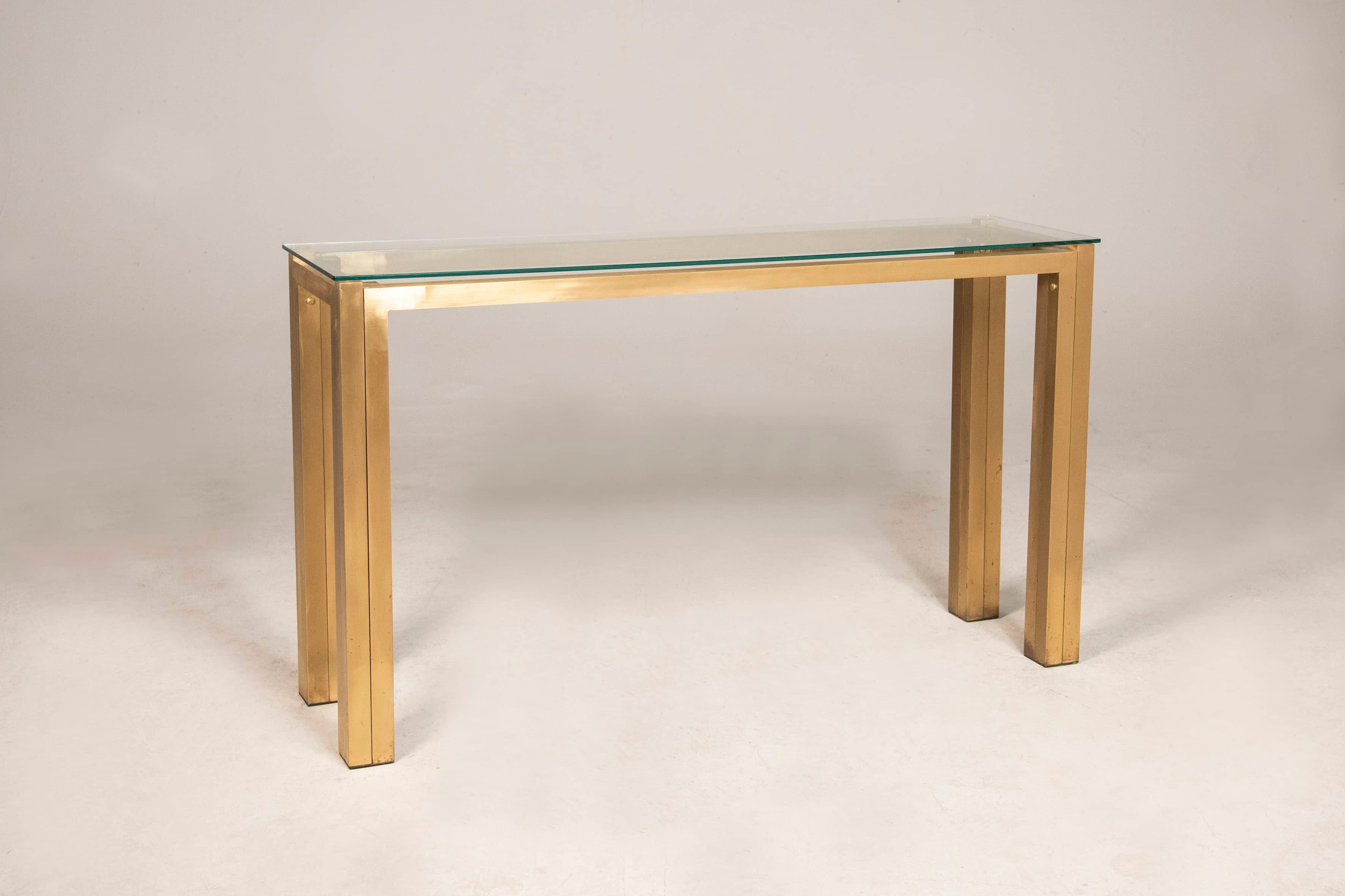 Brass console table with glass top for room center or wall mounting from the 1970s by Willy Rizzo. 

The console table has a frame with brass legs and a square base, attached to each other with round studs, also made of brass. 

Measures 152 x 42 x