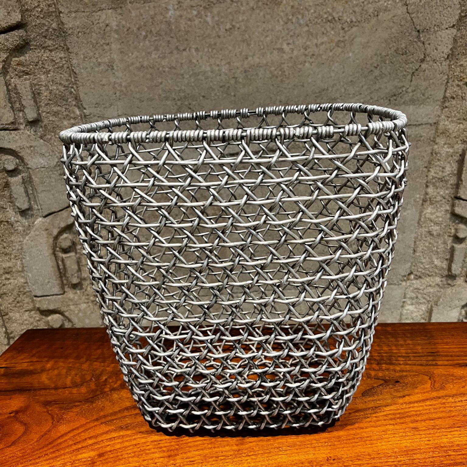 1970s Wire Basket Woven Aluminum Modern Waste Basket Container
Vintage Aluminum
Unmarked
Original vintage preowned unrestored condition. Presents firm and sturdy.
Measures: 12.75 H x 13.25 W x 10.25 D inches
Refer to images listed.

