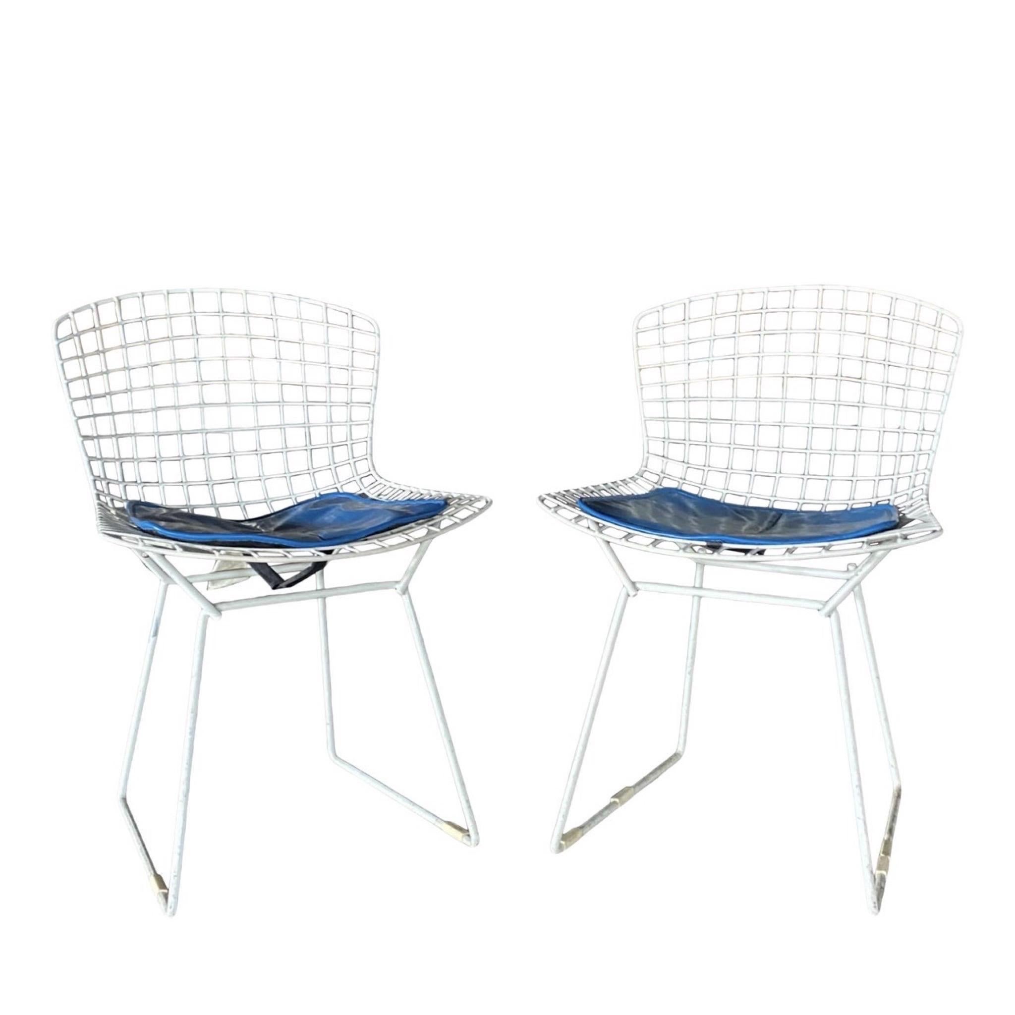 The white wire Bertoia side chair is one of the greatest classic mid-century modern chairs around. And this set of two has royal blue seat pads to boot! However, if you don’t like the seat cushions, they may be removed. Both are in wonderful vintage