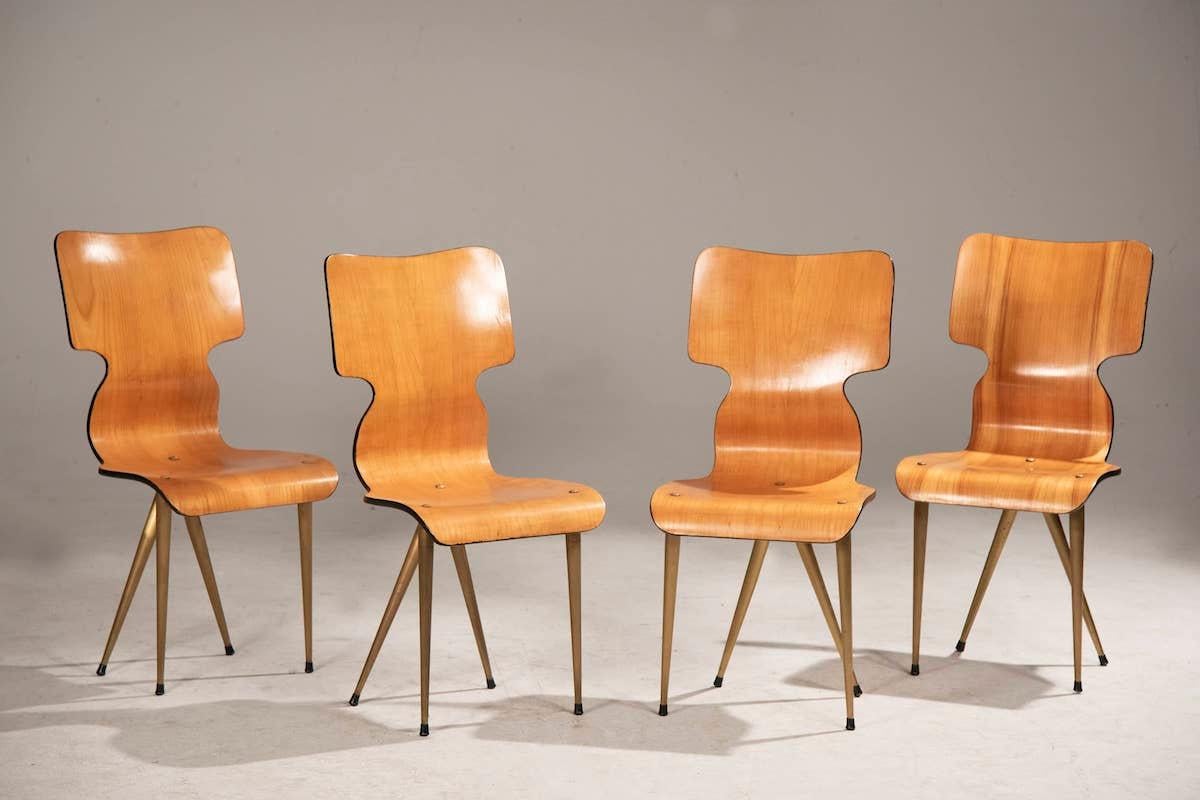 Four chairs from the 1970s with bent plywood frame, legs and brass details. 
The chairs are of Italian provenance. 

Measurements: 41 x D 48 x H 87 

Price INCLUDES the costs for any packaging and crates needed to protect the item and keep the item