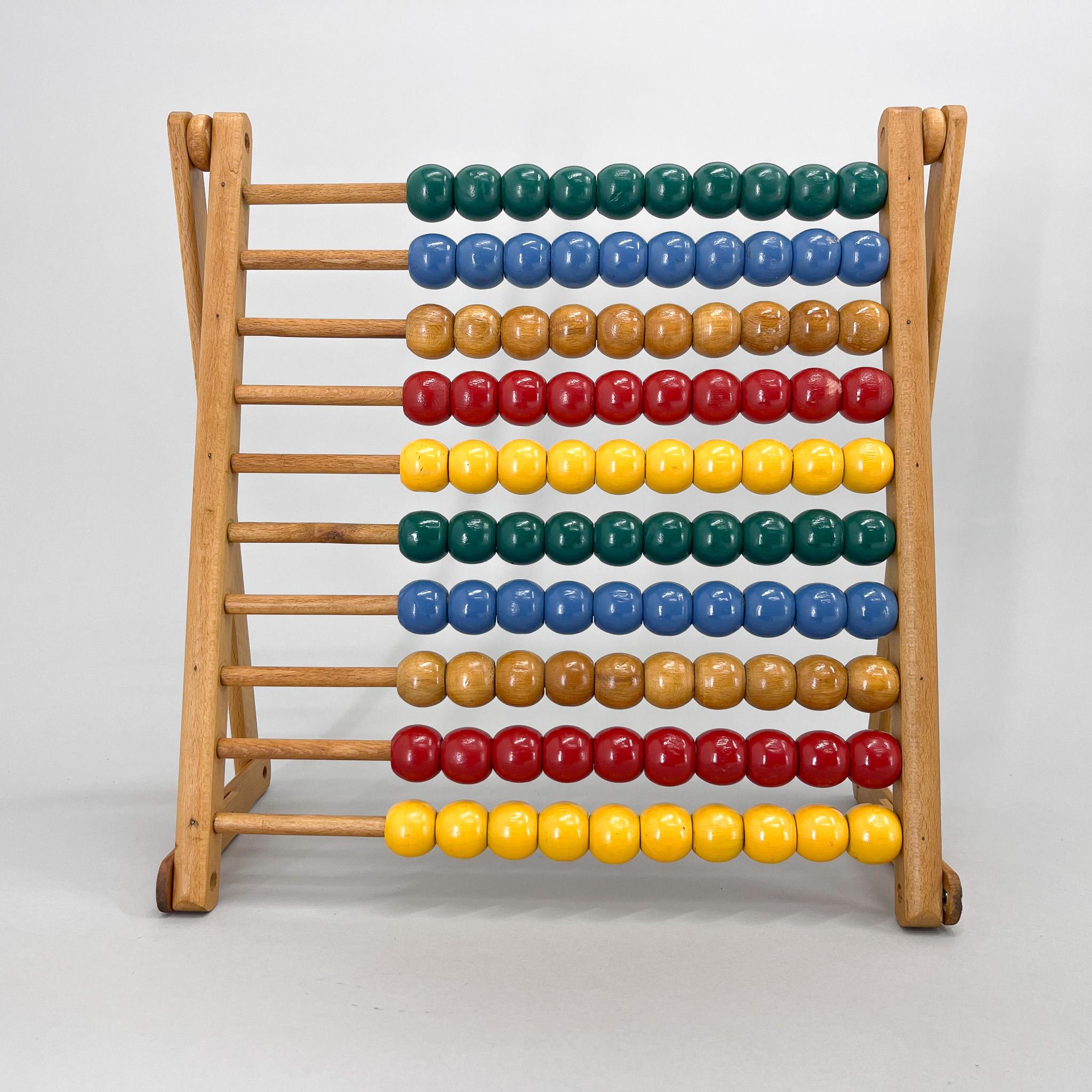Mid century wooden colorful abacus that was used in schools in the 1970s. Can be folded as shown in the pictures. Good original condition.