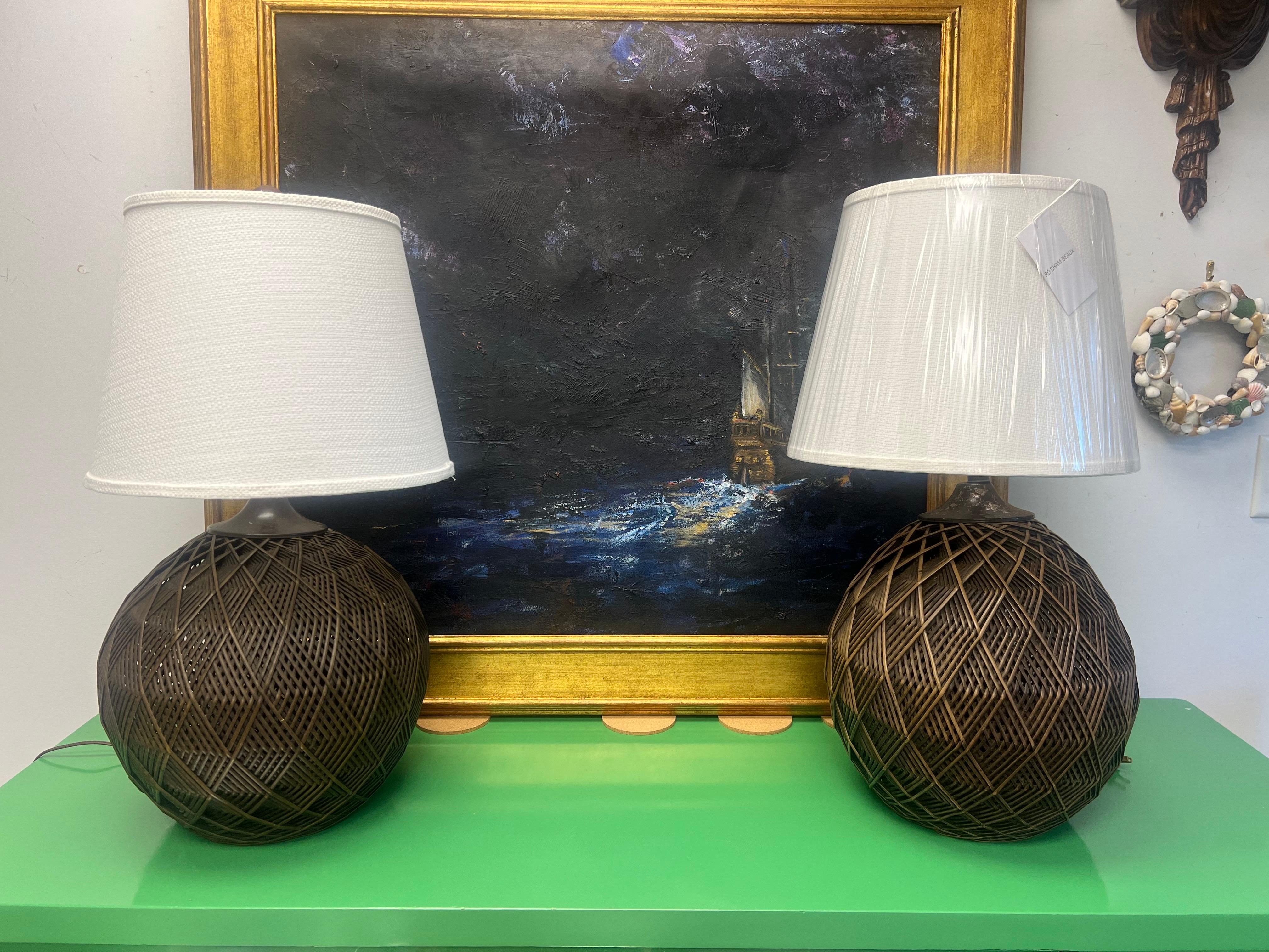 A pair of 1970’s Woven Wicker Geometric Table Lamps With Ro Sham Beaux Shades

Pair of midcentury table lamps with an ingenious multi-layer geometric woven rattan technique that creates sculptural and emotional depth. 

Lamps with shades, harps and