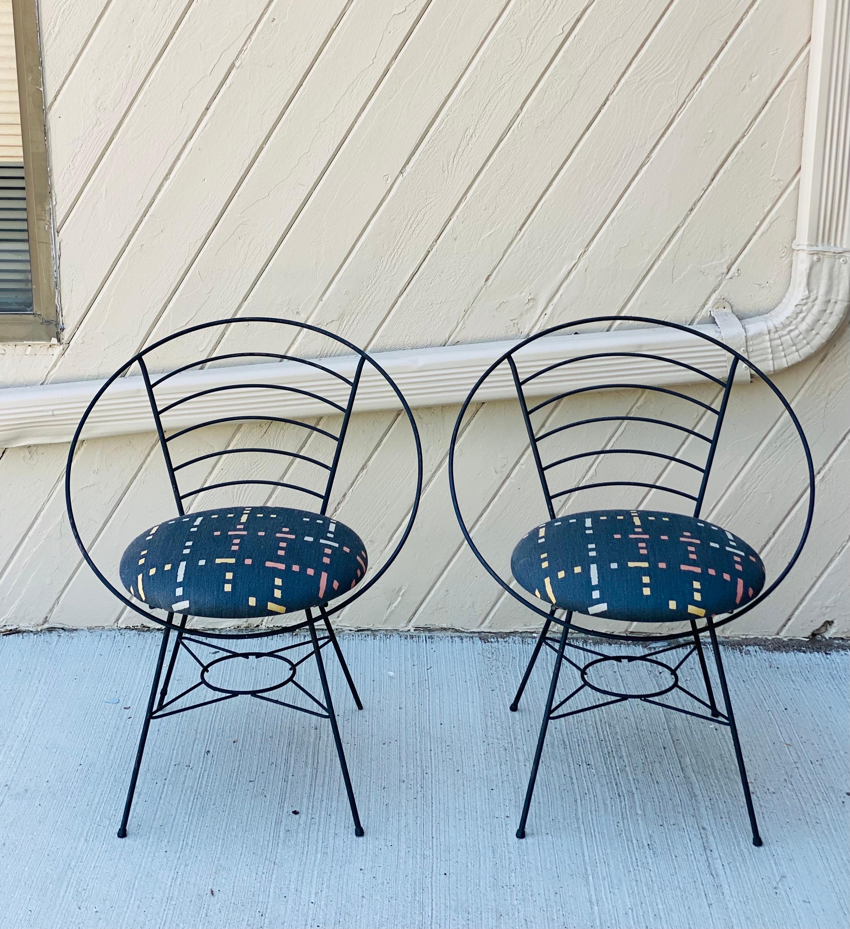 We are very pleased to offer a fun, modern pair of hoop chairs, circa the 1970s. This style of chair has always been a staple of midcentury style and has been interpreted by many different designers. These chairs showcase a streamlined, Minimalist