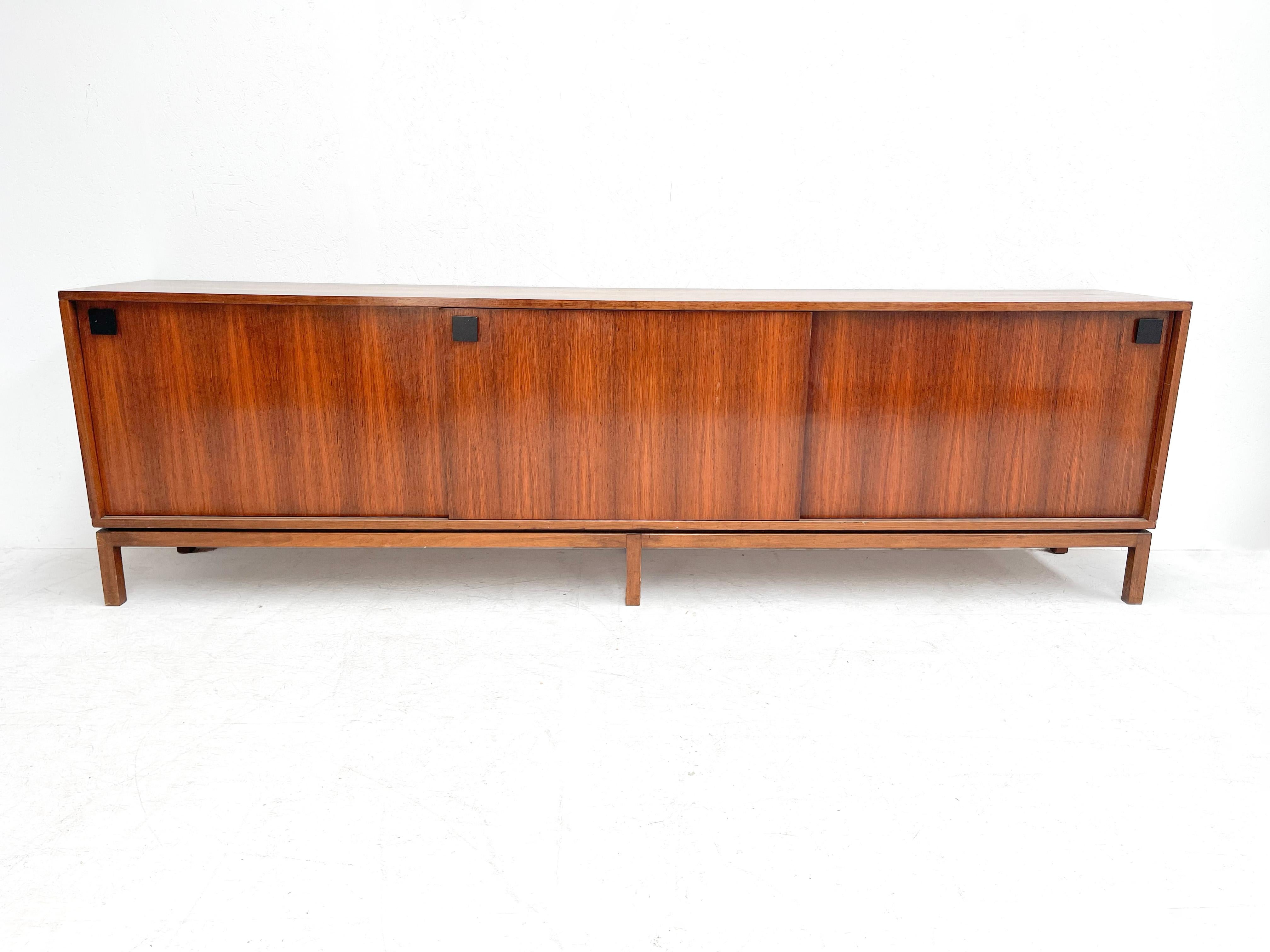 Alfred Hendrickx rosewood sideboard
This sideboard was designed by one of Belgium's most famous designers Alfred Hendrickx. He designed it in the 1960s for the Belgian manufacturer Belform. 
 
The sideboard has three sliding doors with black