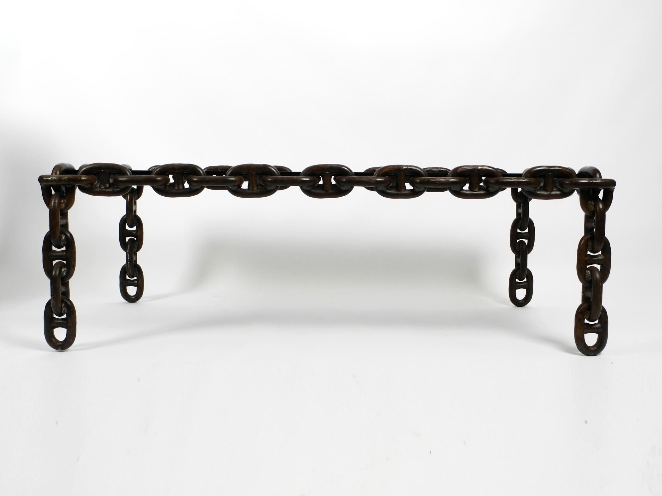 Wonderful, very rare and heavy coffee table made of large rust-brown lacquered nautical iron chains.
Above is a polished, thick smoked glass plate in mint condition.
Great brutalist design from the 1970s. Manufacturer unknown.
Very solid, high