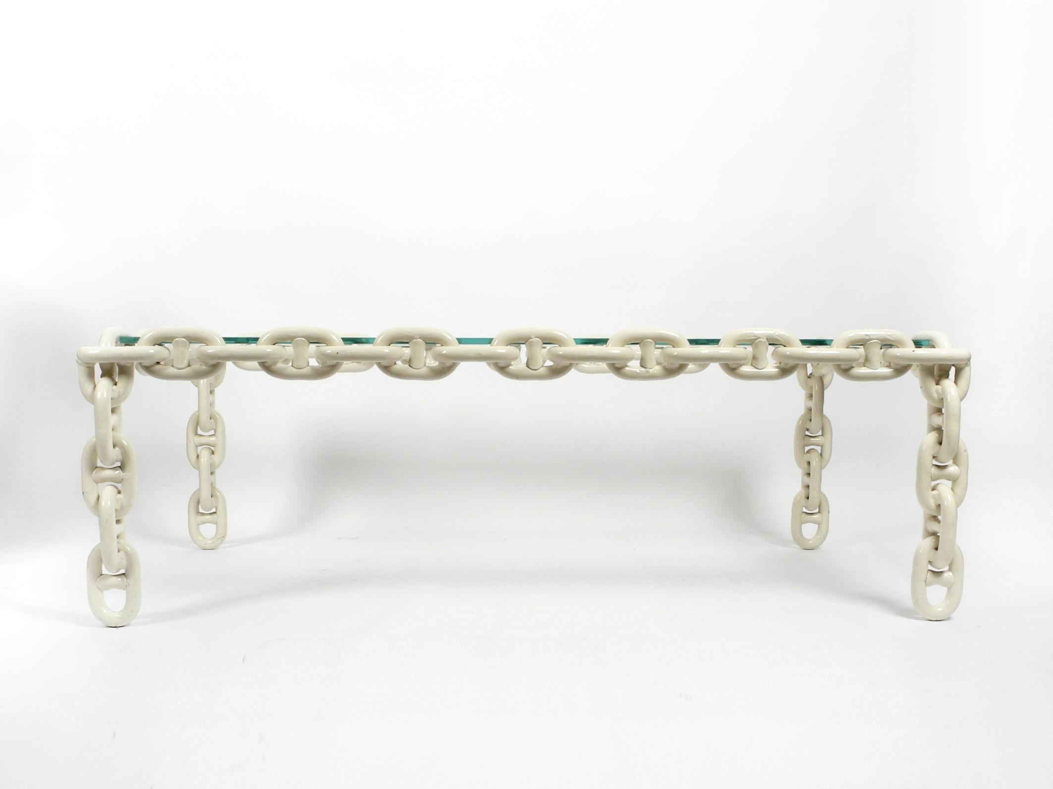 Beautiful, very rare and heavy coffee table made of large, white lacquered nautical iron chains.
Above is a polished, thick clear glass plate in mint condition.
Great Brutalist design from the 1970s. Manufacturer unknown.
Very solid, high quality