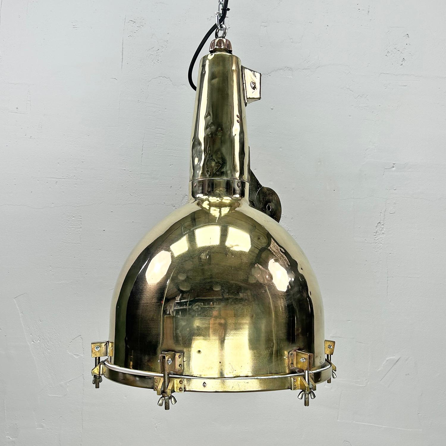 The large brass pendant light is a reclaimed vintage searchlight from decommissioned Japanese cargo ships built during the 1970's. Professionally refurbished, these original brass ceiling lights are ideal for creating authentic
