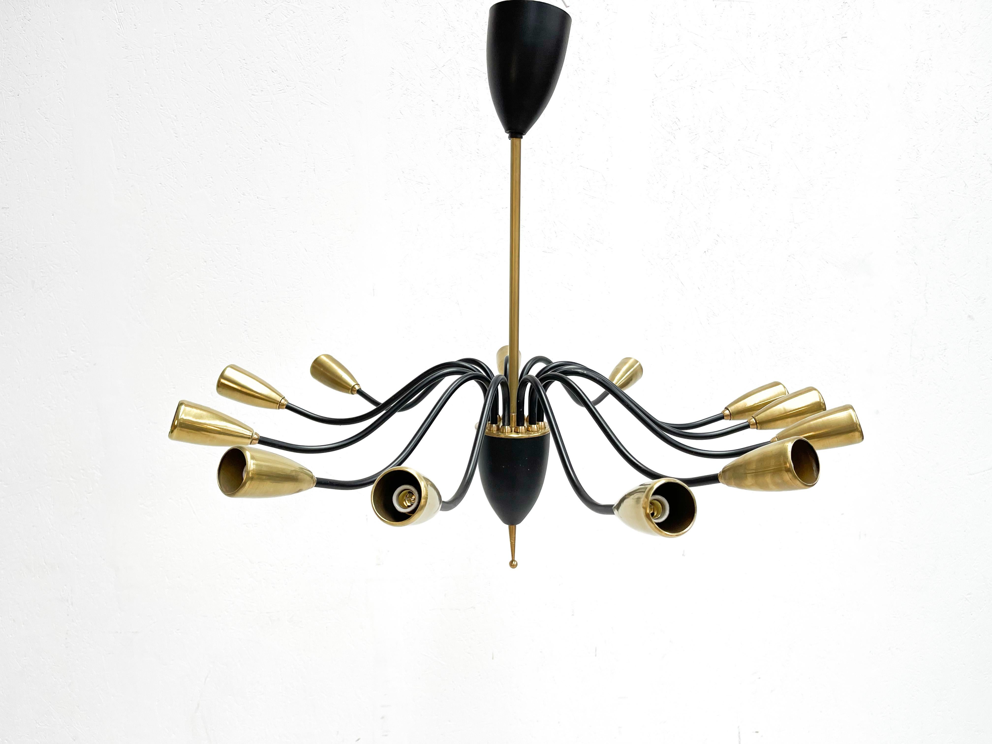 1970s spider chandelier of unknown Belgian manufacture.
This type of chandelier is also called the 