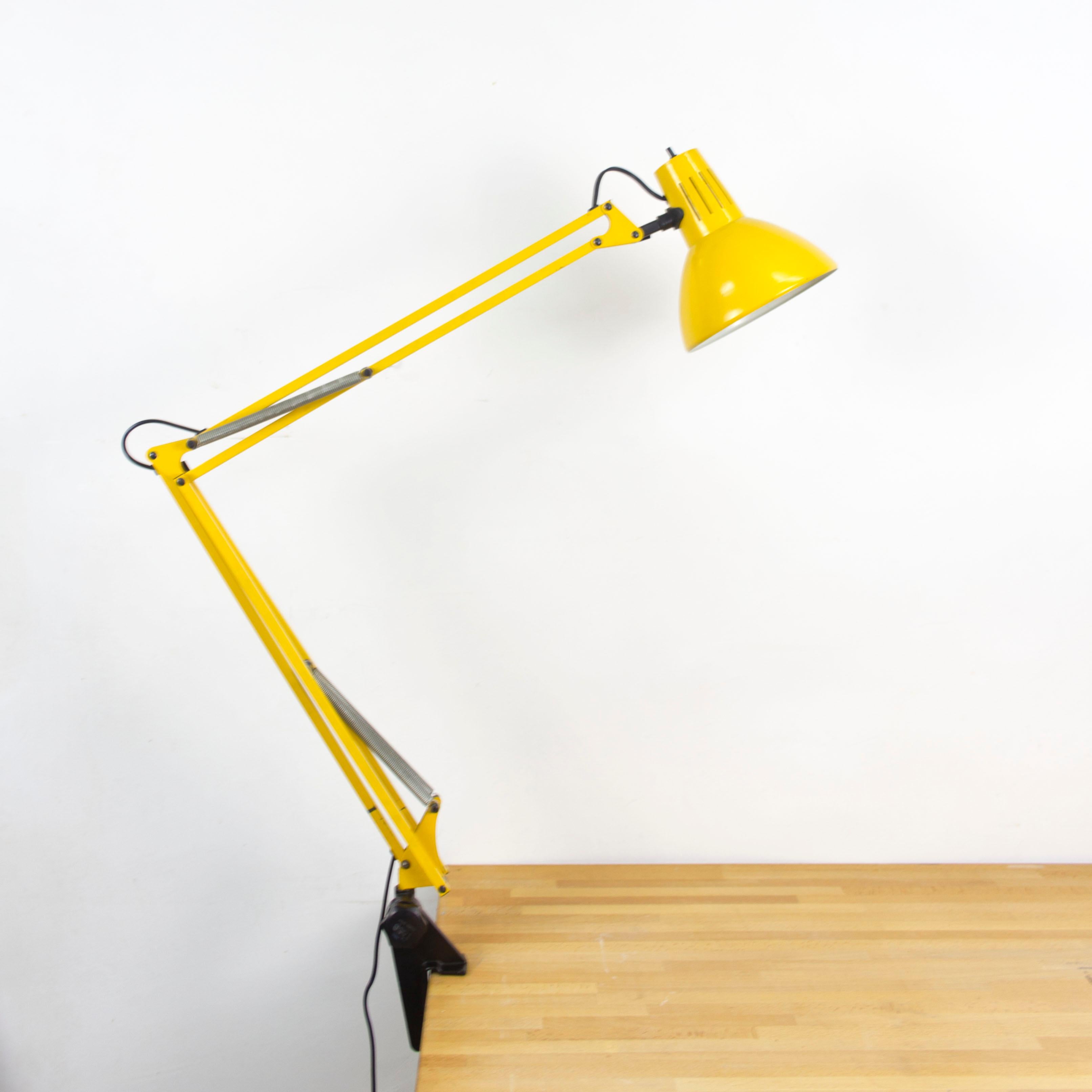 Yellow architect lamp by Fase, metal, European plug (up to 250V), 1960s. 

This yellow architect lamp has two movable arms. It was produced by the lighting manufacturer Fase in Madrid, Spain and comes with the original support bracket to attach