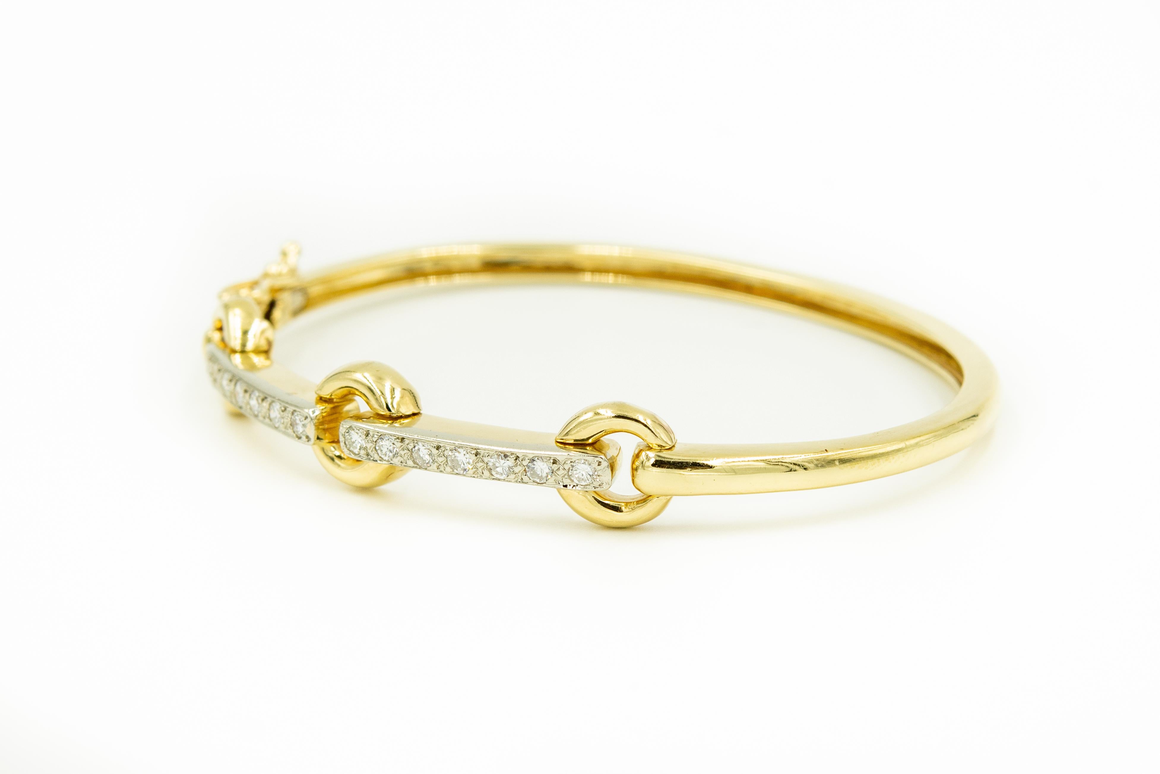 Late 20th century streamline 14k yellow gold bangle bracelet featuring three open circles with two diamond bars between them.  There are  seven .03 carat single cut  diamonds in each.  The approximate total diamond weight is .42 of single cut