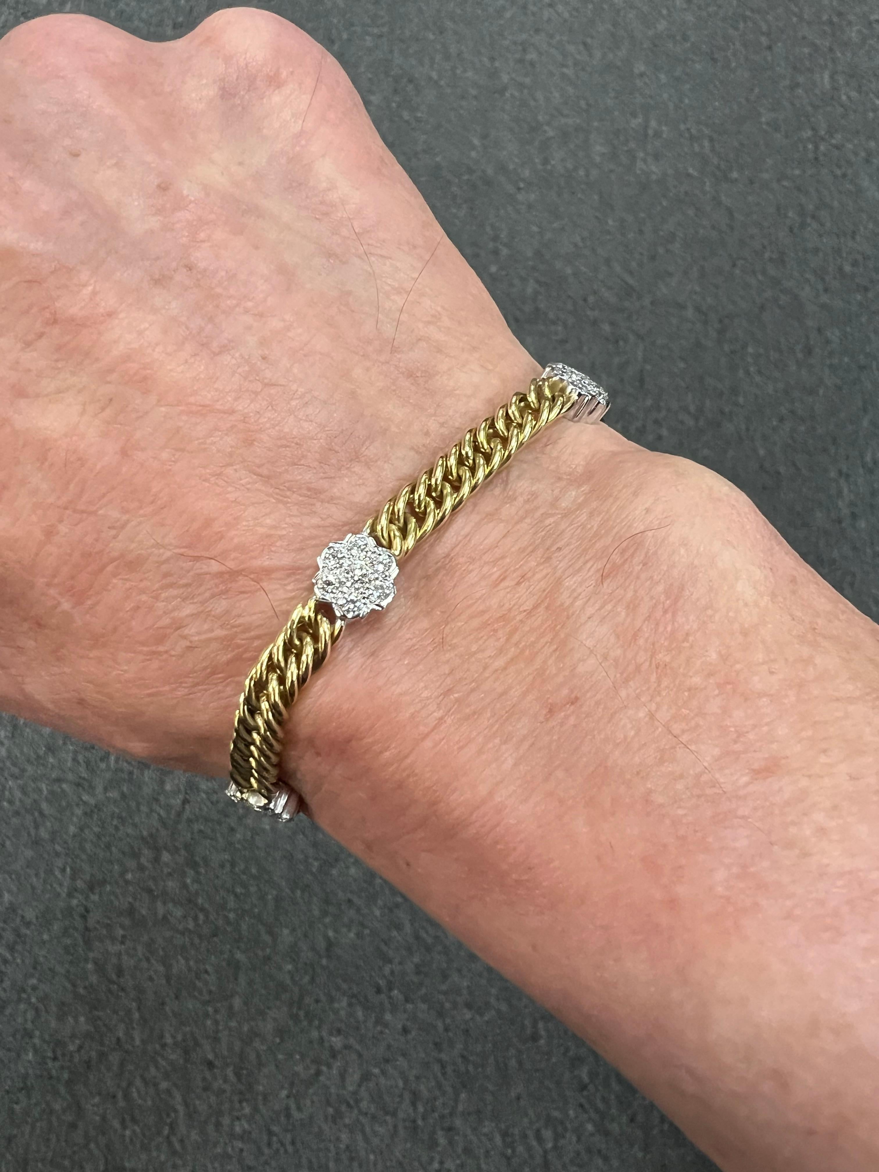 1970s Vintage 18k yellow gold diamond link bracelet.

This Vintage 18k yellow gold and diamond link bracelet from the 1970s is a very wearable bracelet.  Designed with five diamond floret sections in white gold interspersed between tightly woven