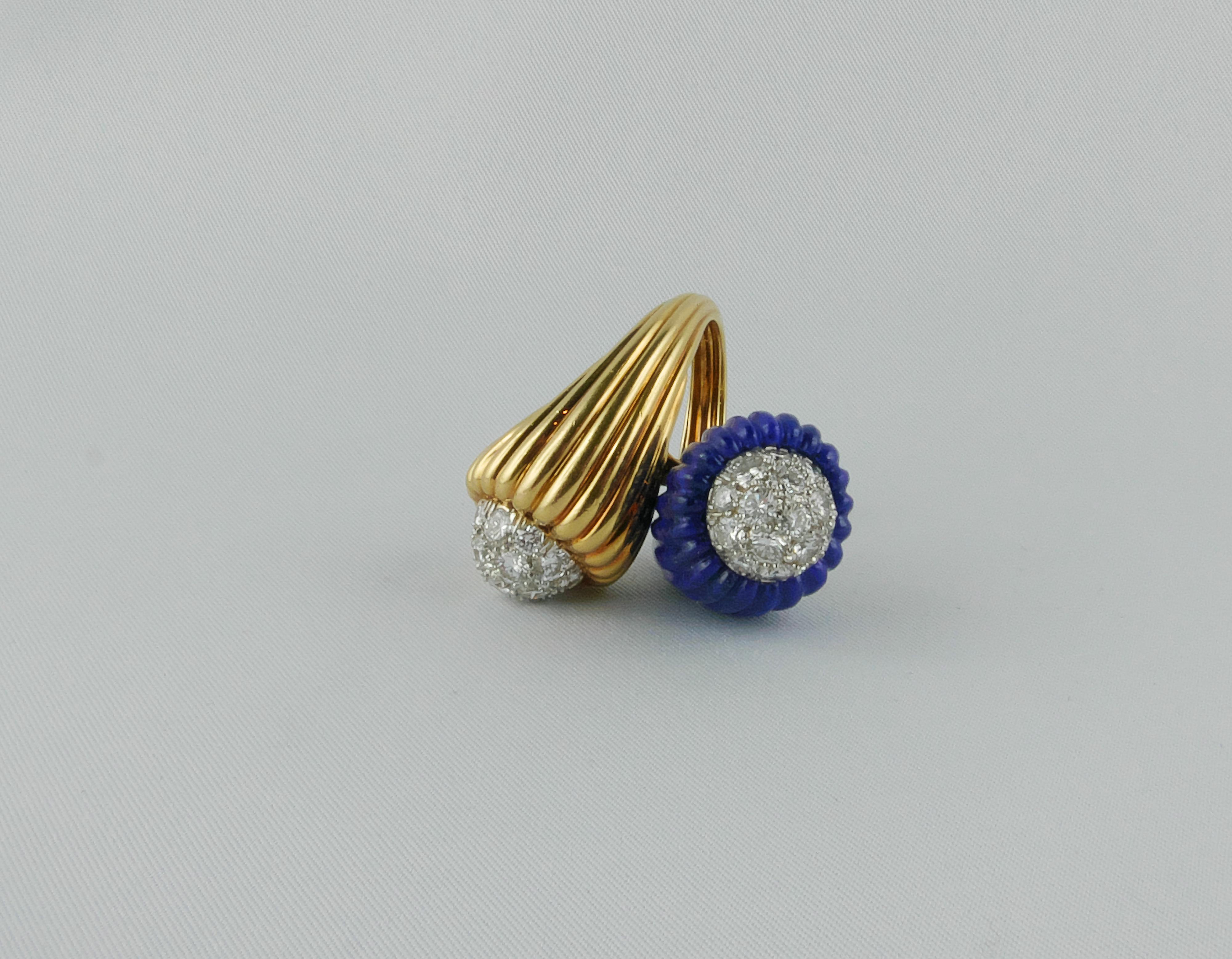 Distintive and imposing  Ring exquisitely crafted in the 1970’s
The finely scalloped Lapislazuli creates a contrarié mounting with the scalloped Gold end, both are accented by round cut Diamonds, set in Platinum in a domed motif, to add superb