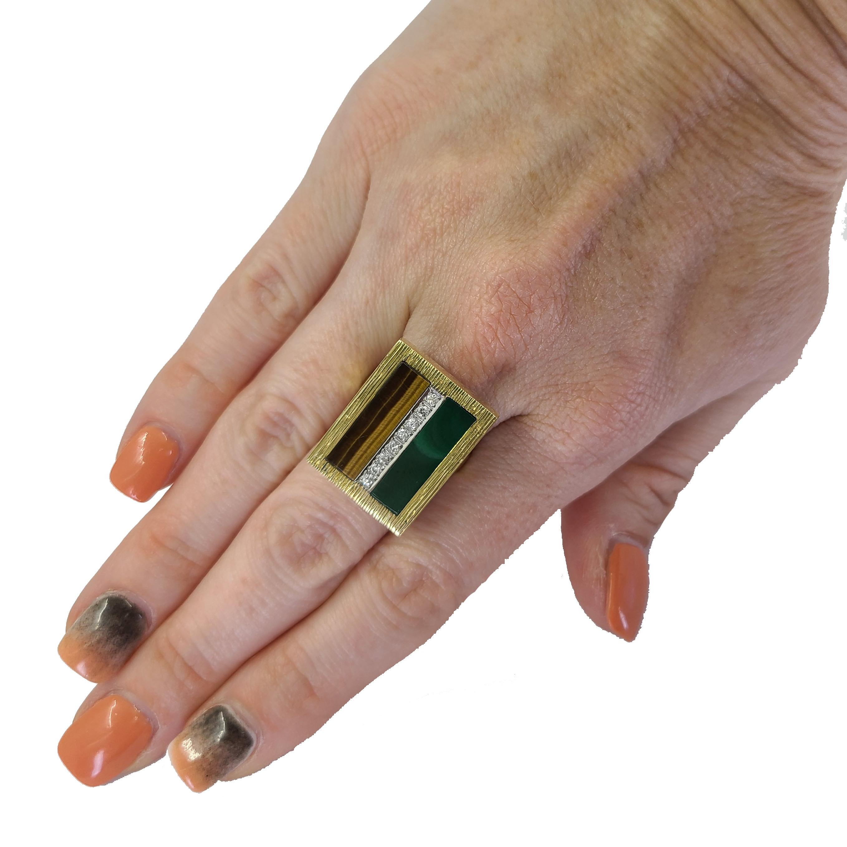 18 Karat Yellow Gold Textured Rectangular Ring Featuring Tiger Eye & Malachite Inlay Accented By 8 Round Diamonds Of VS Clarity & G/H Color Totaling 0.16 Carats. Finger Size 6.75. Finished Weight Is 9.0 Grams.