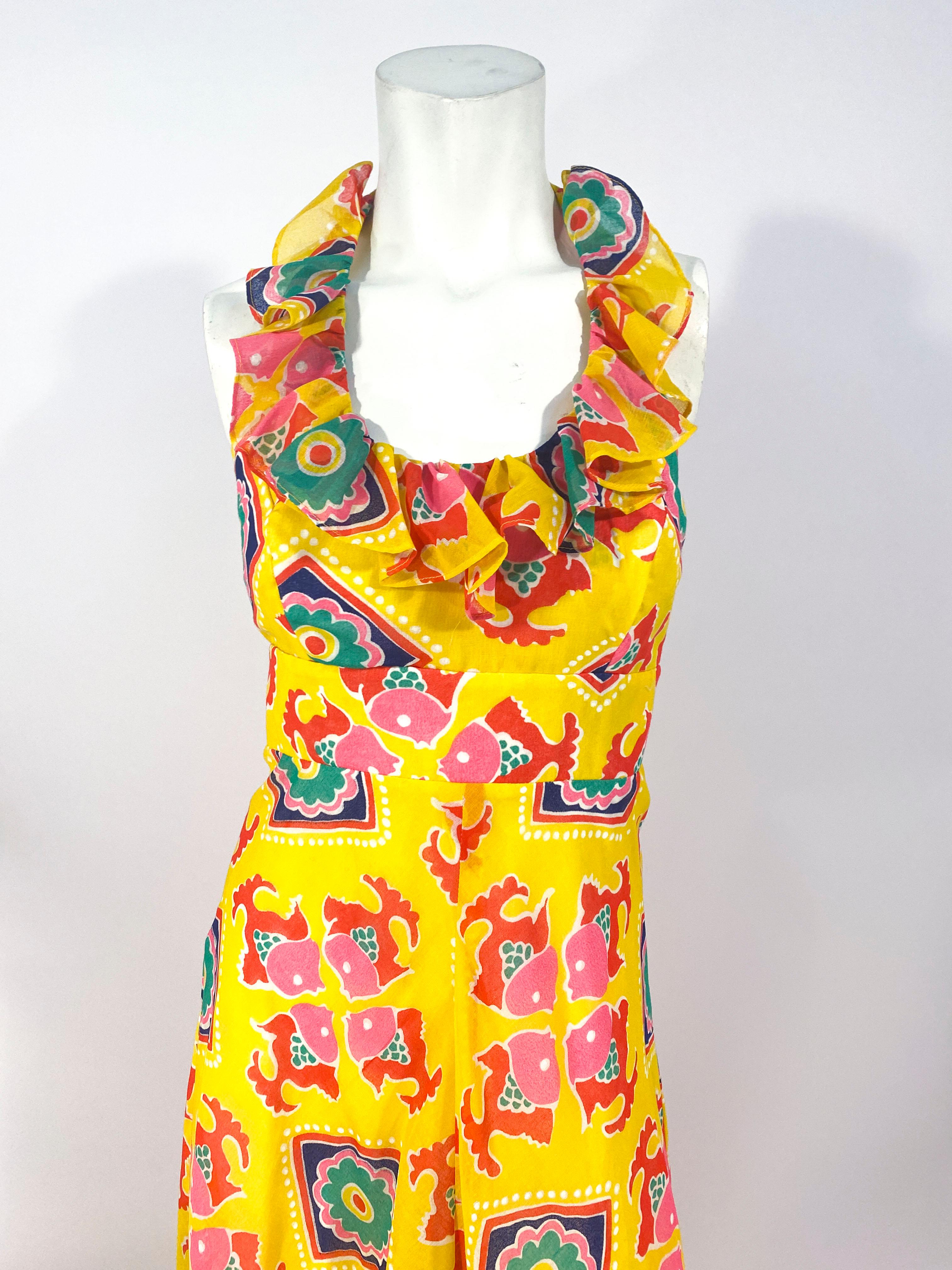 1970s yellow printed maxi dress with a tie-back halter top decorated with ruffles. Since this halter top ties in the back of neck the length is adjustable.
