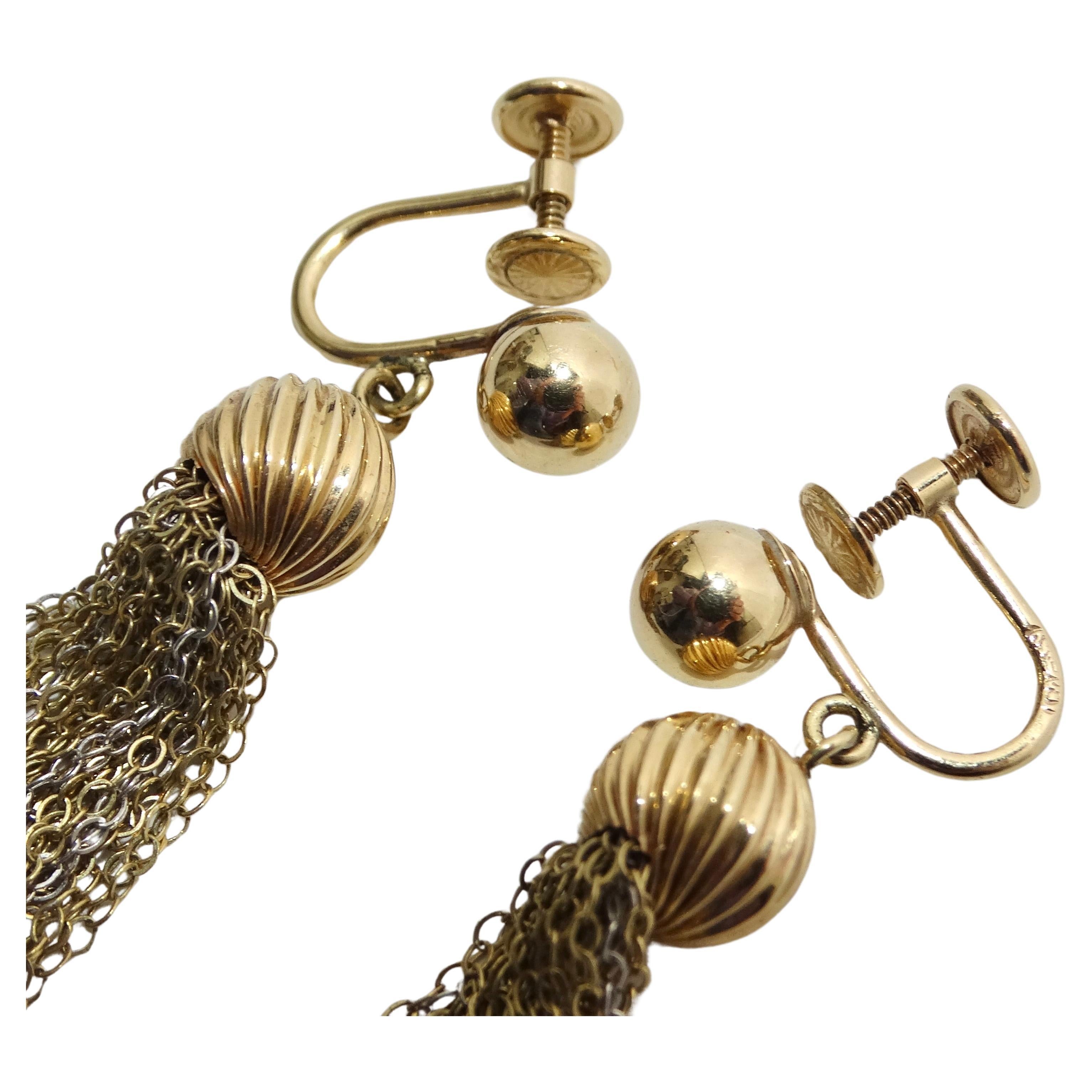 The 1970s Yellow & White 14K Gold Chandelier Earrings are a dazzling accessory, designed to add a touch of elegance and glamour to your style. These earrings are a true reflection of the classic chandelier design. They feature a yellow gold ball