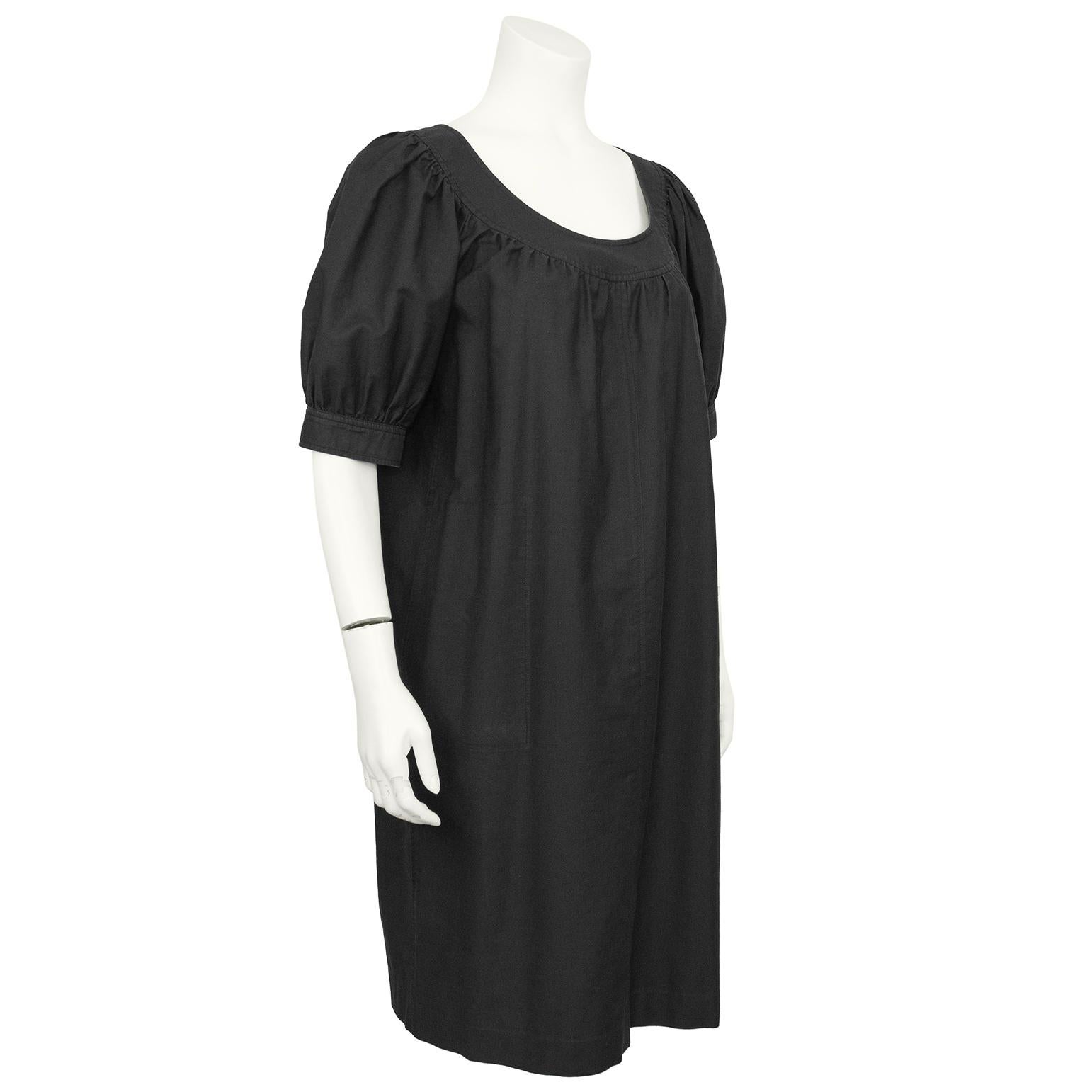 1970s YSL black cotton peasant style tunic dress with pouf sleeves and a scoop neckline. The dress can be worn over pants or belted. Two large front pockets with side seam entry. In excellent condition, fits like a US 4/6, marked a FR 38. Dry