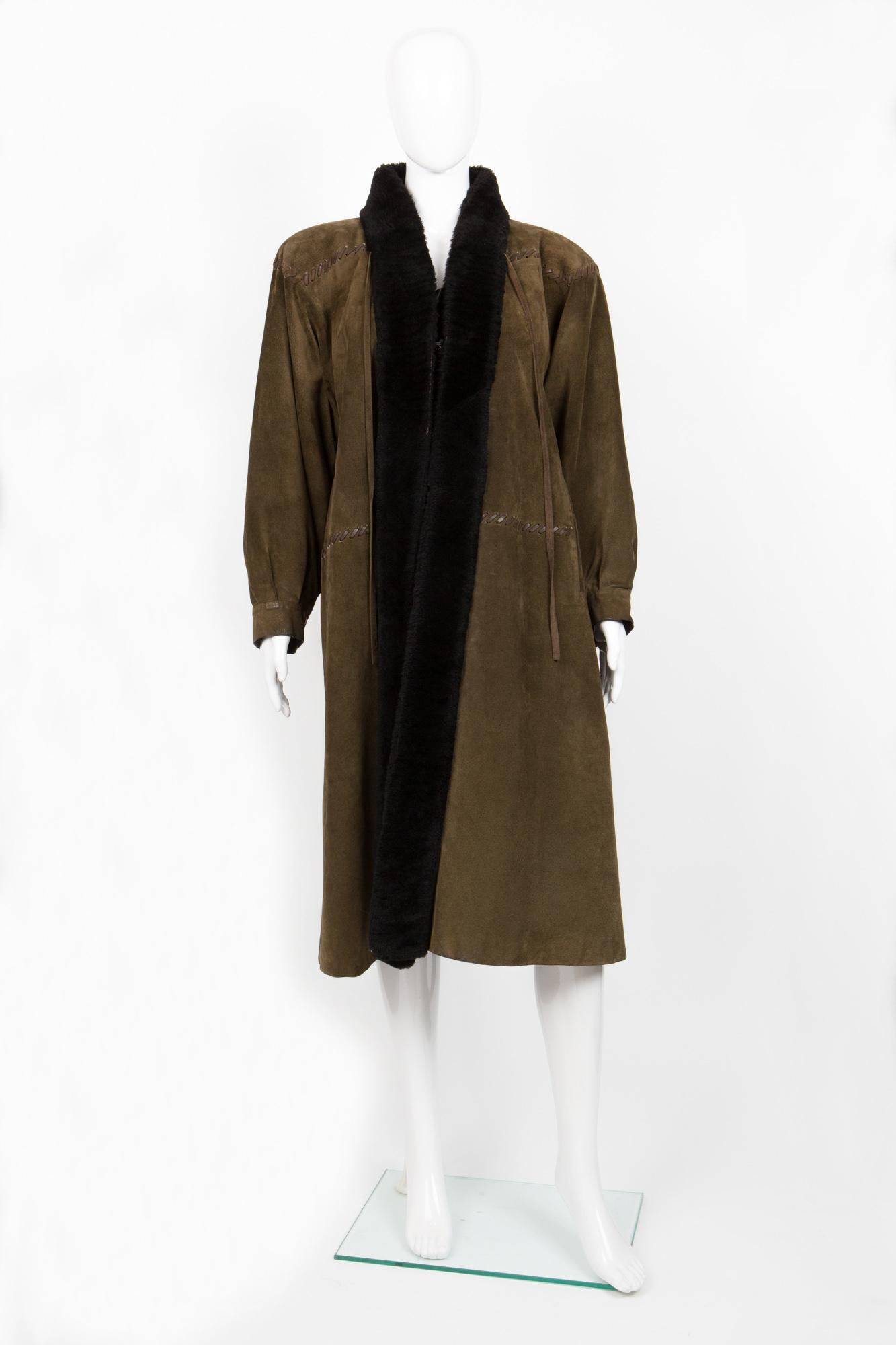 Saint Laurent khaki green suede long coat featuring  leather saddle stitchings, brown shearling full interior lining,  a front hook closure fastening.
Made in France. 
In vintage condition ( Due to his age, some suede parts & furs are
