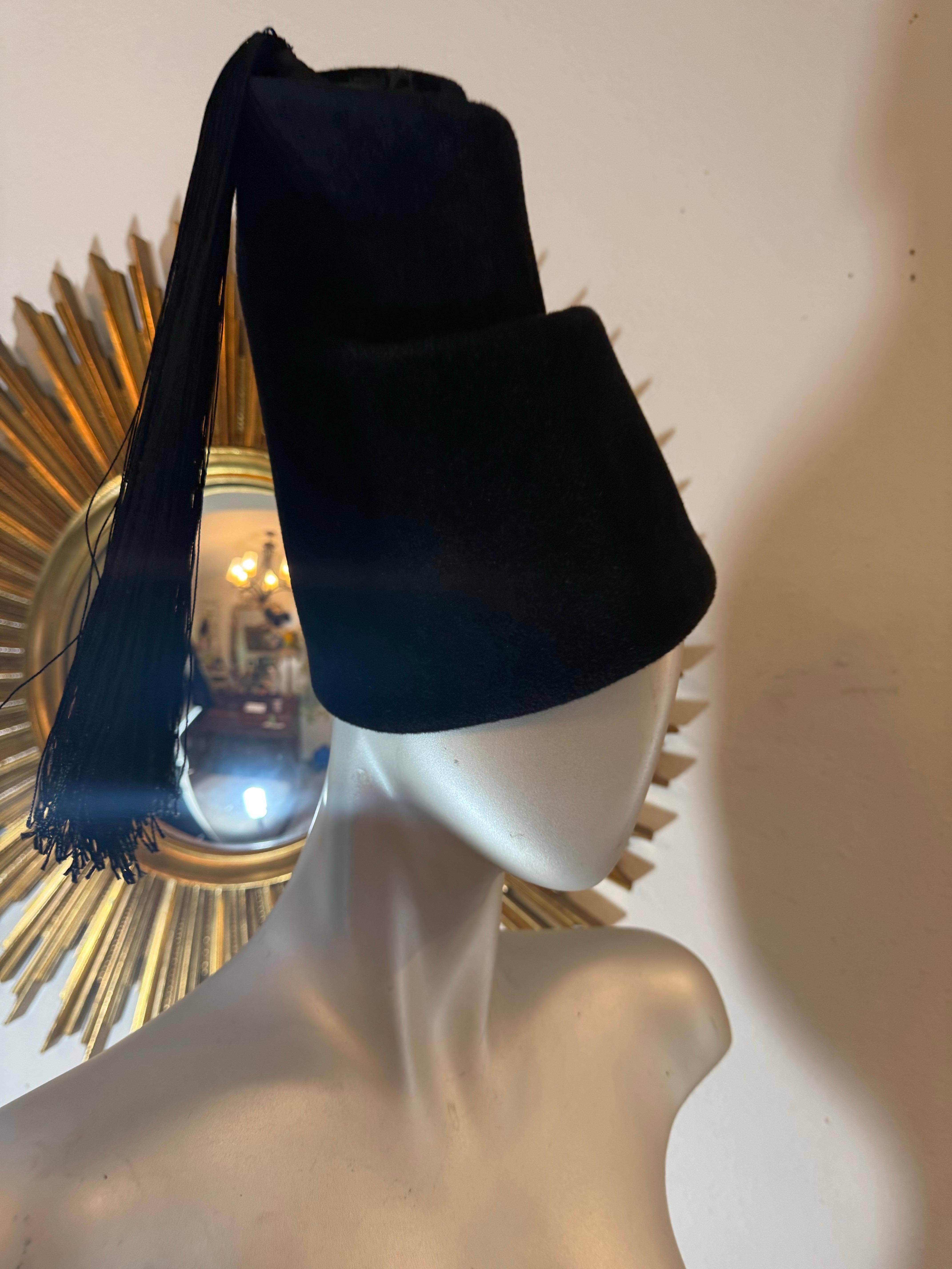1970s Yves Saint Laurent Avant Garde Turkish-Inspired Spiral Toque w Tassel: Very rare, one-of-a-kind black Fall/Winter fur felt sculpted to the heavens in a tiered spiral twist---a whirling dervish delight, with a lengthy black silk braided tassel.