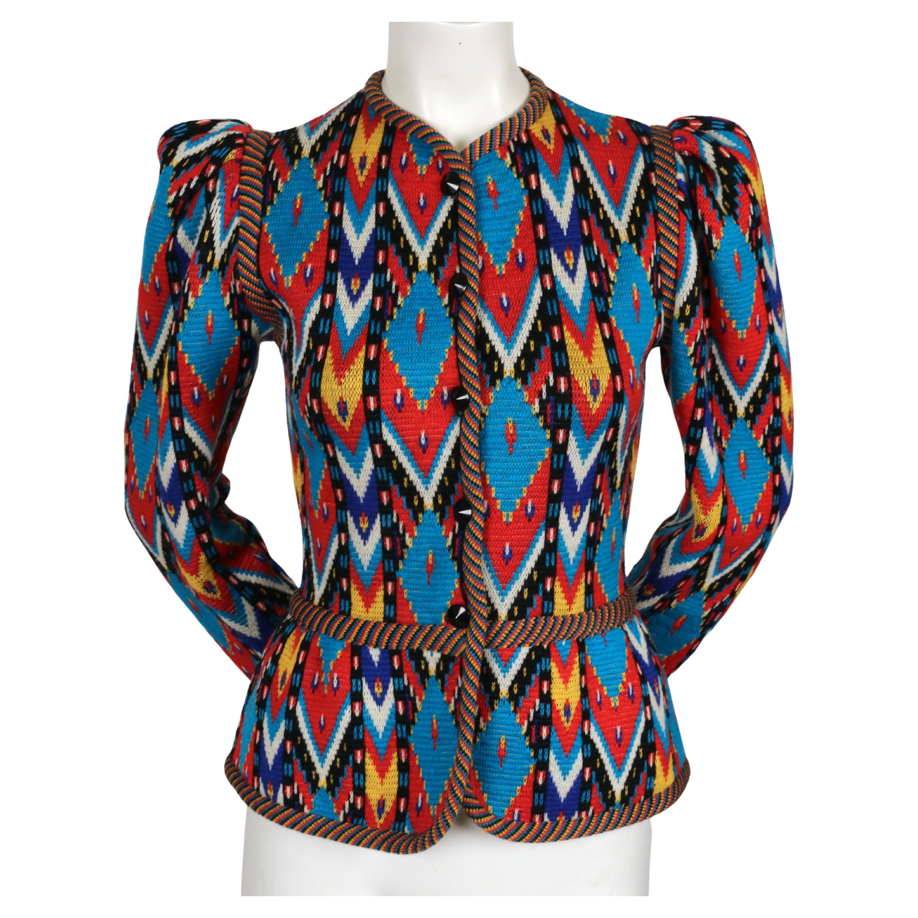 Multi-colored, Ikat patterned, woven wool cardigan with puff sleeves and peplum hem detail designed by Yves Saint Laurent dating to fall of 1979. Labeled a French size 36. Approximate measurements (unstretched): shoulder 14