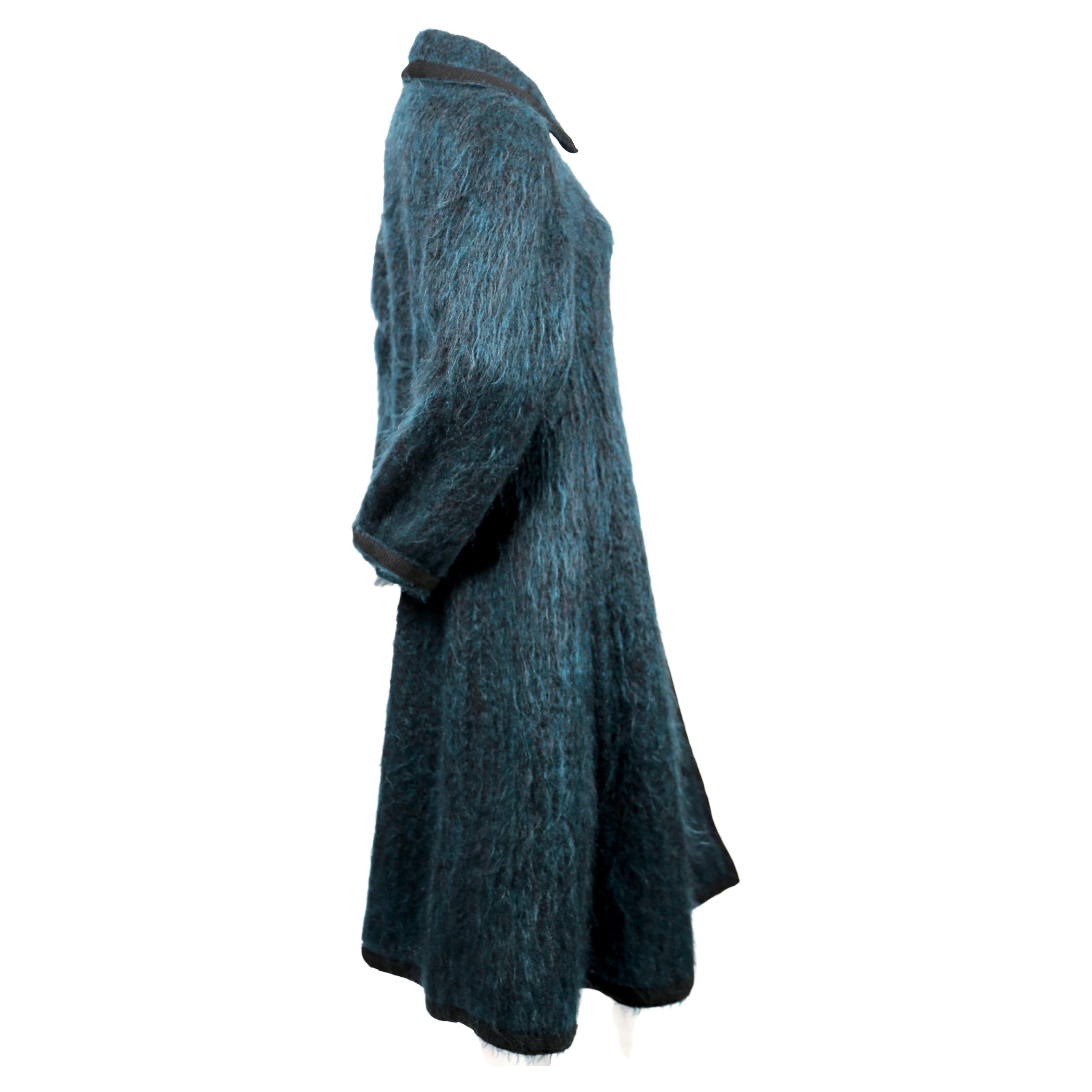 Dramatic, blue-green, brushed-wool coat with black trim and buttons from Yves Saint Laurent dating to the late 1960's. Coat is labeled a French size 38 and fits a US 4 or 6 (33-34