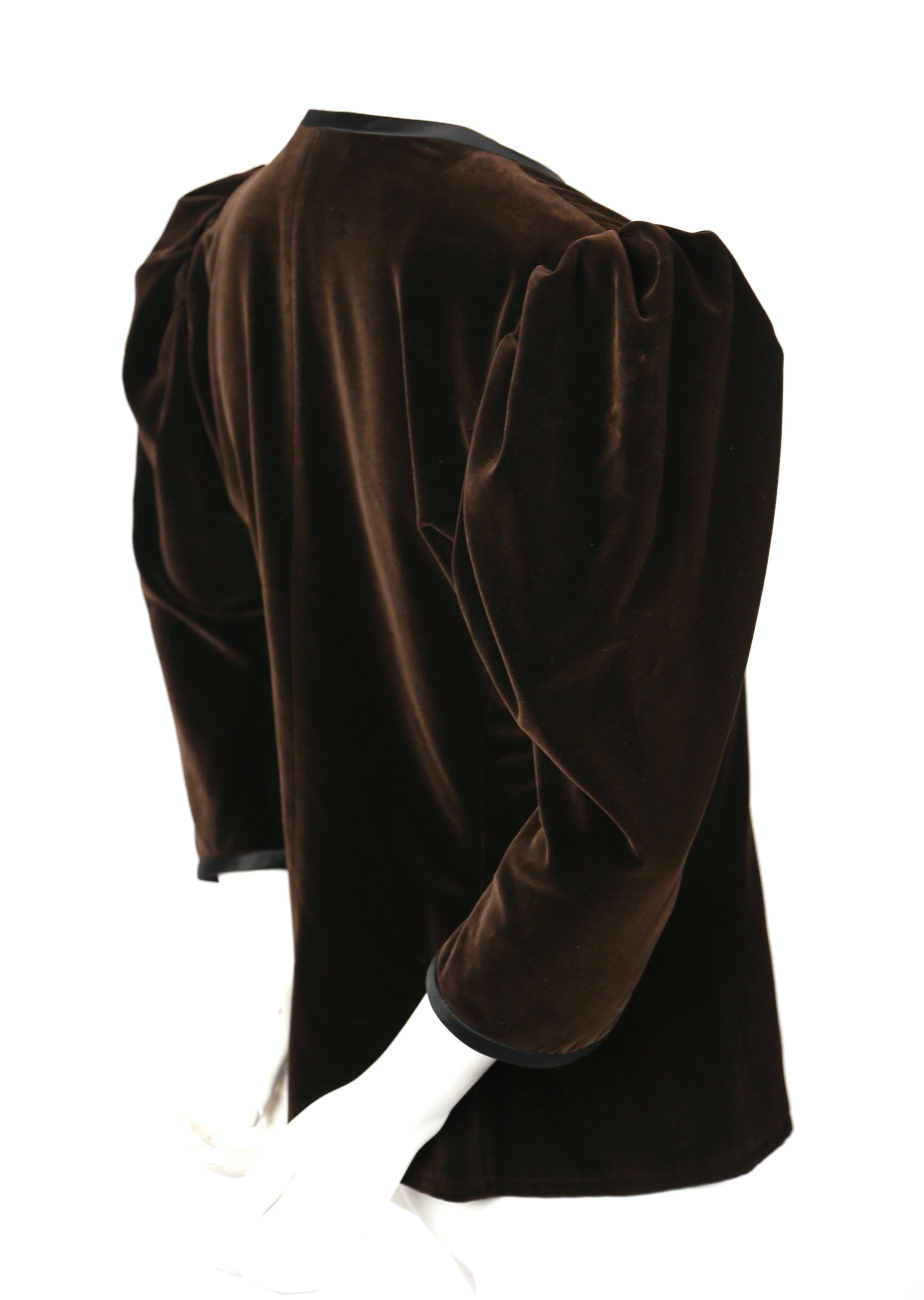 Chocolate brown velvet jacket with black satin trim from Yves Saint Laurent dating to the 1970's. No size is indicated however it best fits approximately a US size 6. Approximate measurements: shoulders 15