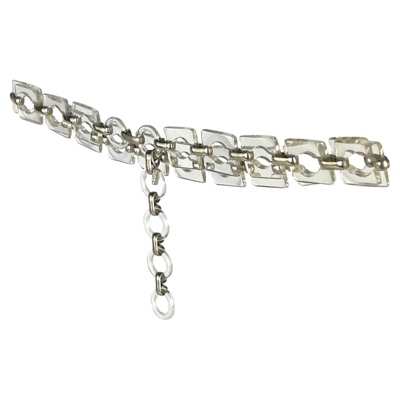 TheRealList presents: a clear acrylic and silver-tone metal Yves Saint Laurent belt, designed by Yves Saint Laurent. From the 1970s, this stunning belt features alternating acrylic round and square pieces connected by silver metal accents. This
