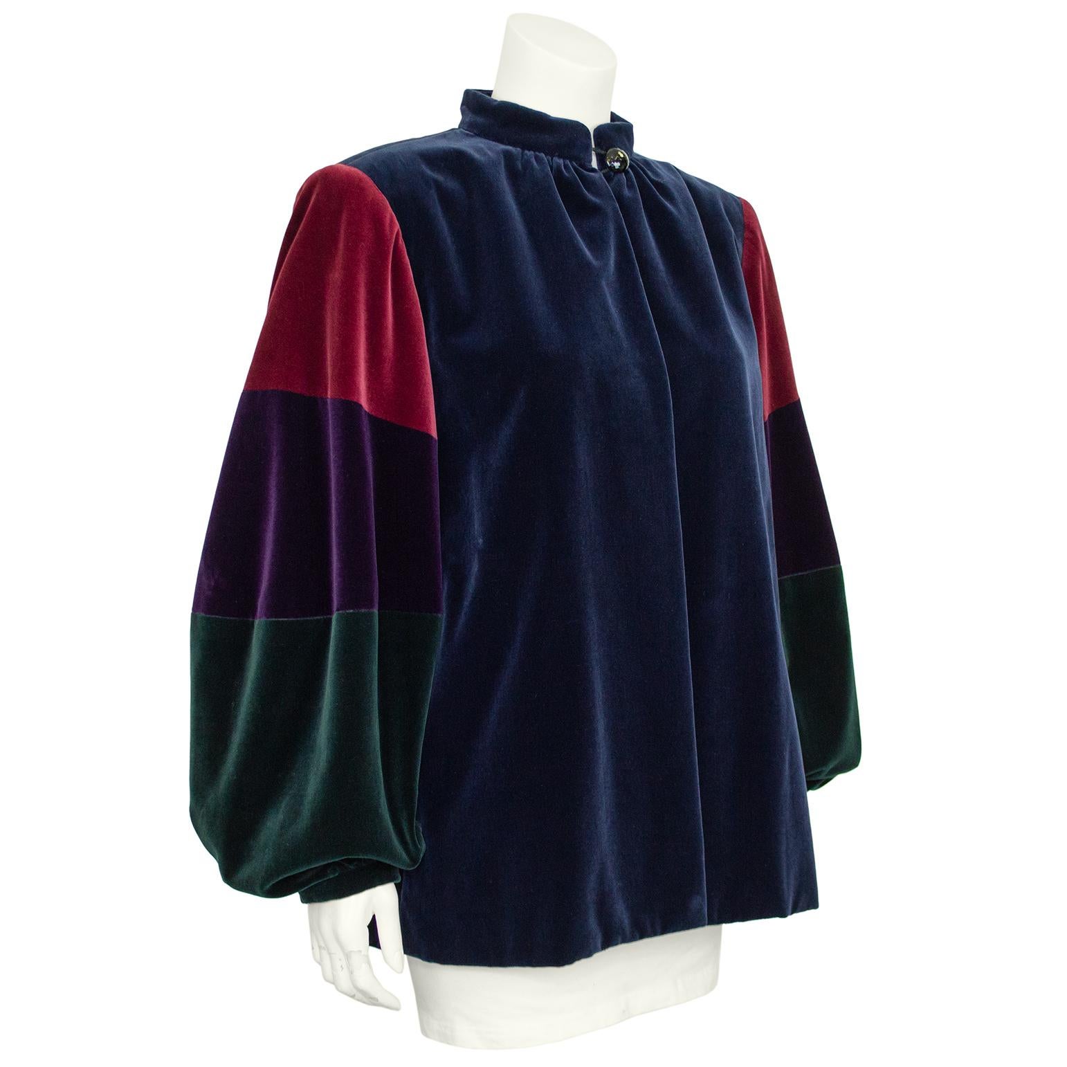 Giacca in velluto di cotone di Saint Laurent degli anni '70, caratterizzata da una vestibilità sciolta a mo' di camice e maniche a sbalzo. Il punto forte di questo capo facile da indossare sono le maniche tri-color verde intenso, viola e bordeau che