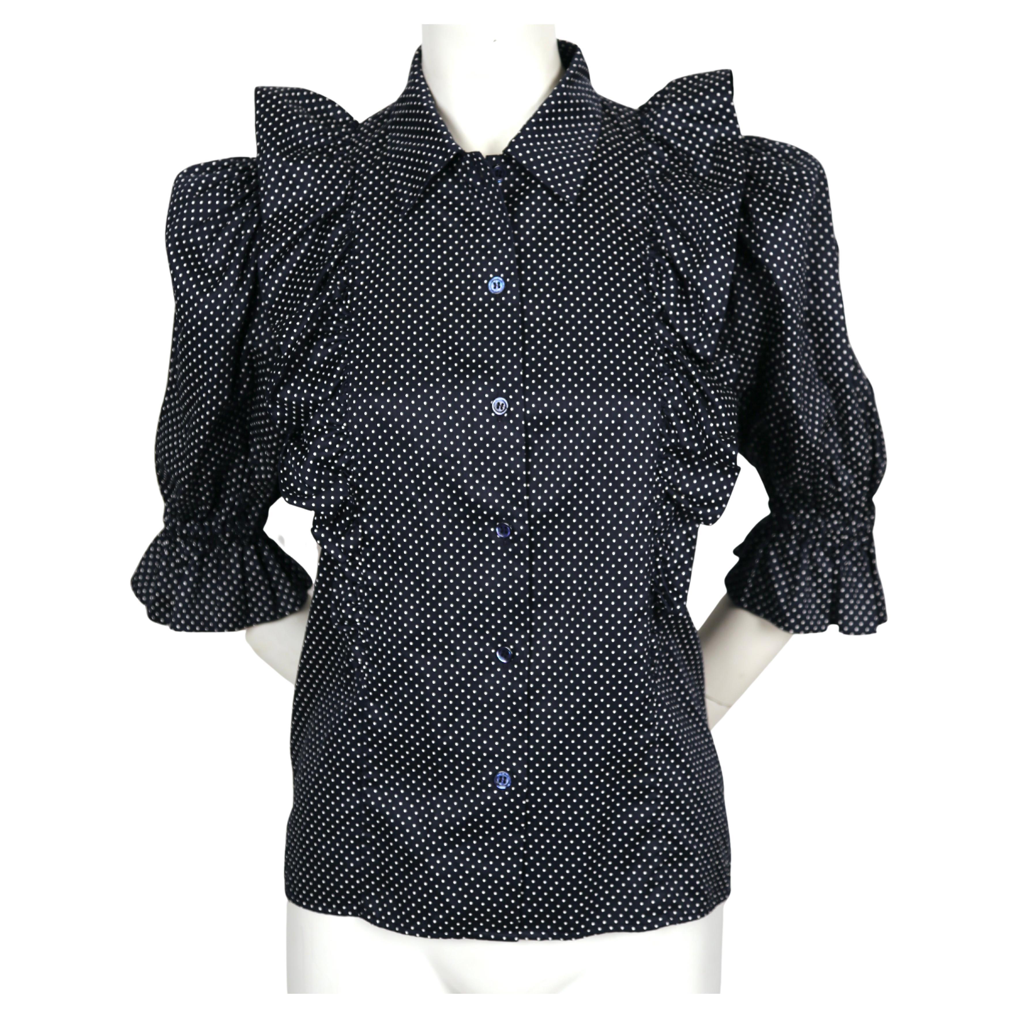 Deepest navy-blue, silk blouse with flounced trim and puff sleeves designed by Yves Saint Laurent dating to the late 1970's, early 1980's. No size is indicated but this best fits a 0 to slim 4. Approximate measurements: shoulder 13.5, bust 34-35