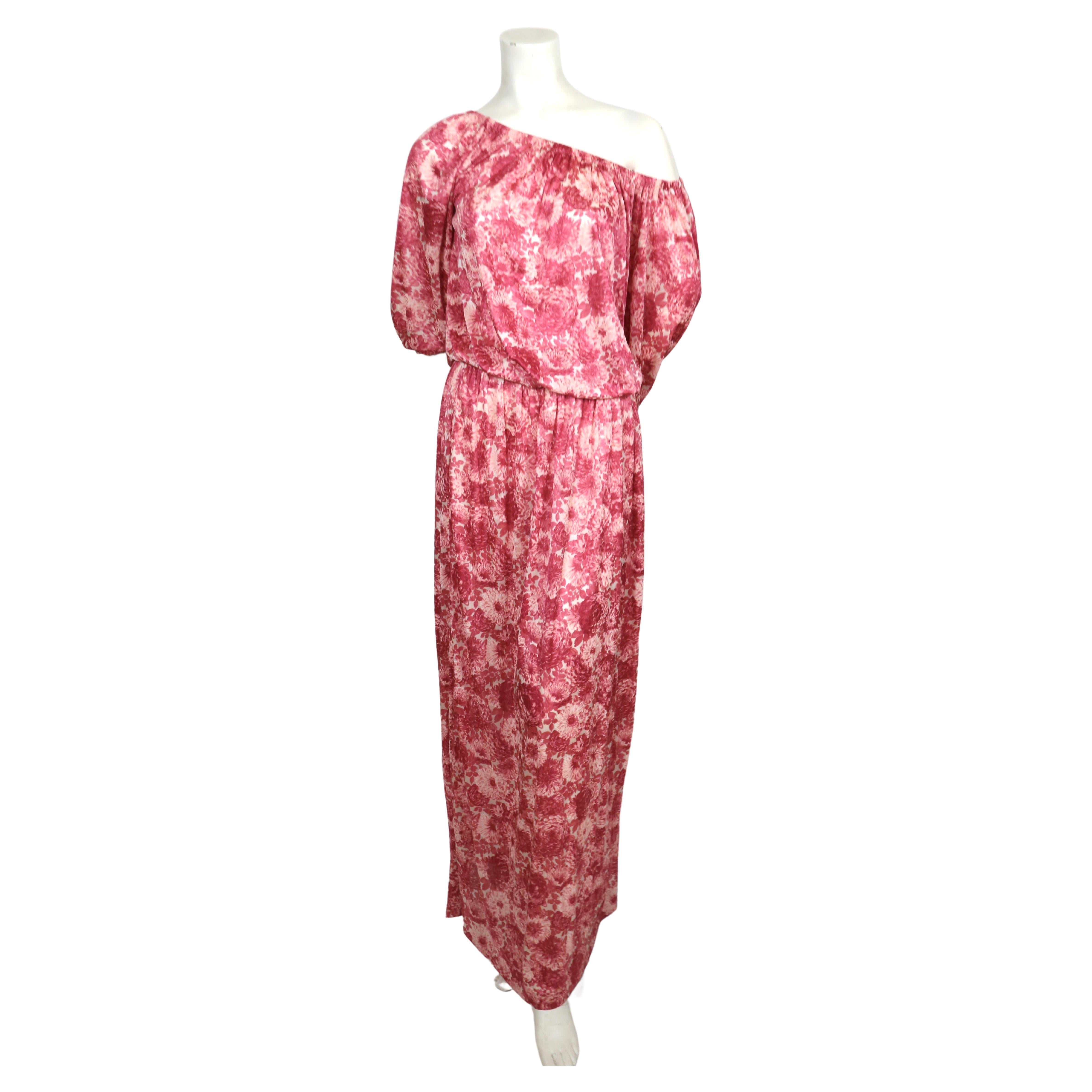 Rose, floral-printed silk jersey dress with elasticized neckline and waist designed by Yves Saint Laurent dating to the 1970's. Labeled a French size 34 however this will easily fit up to a French 38. Dress can be worn on or off the shoulders due to