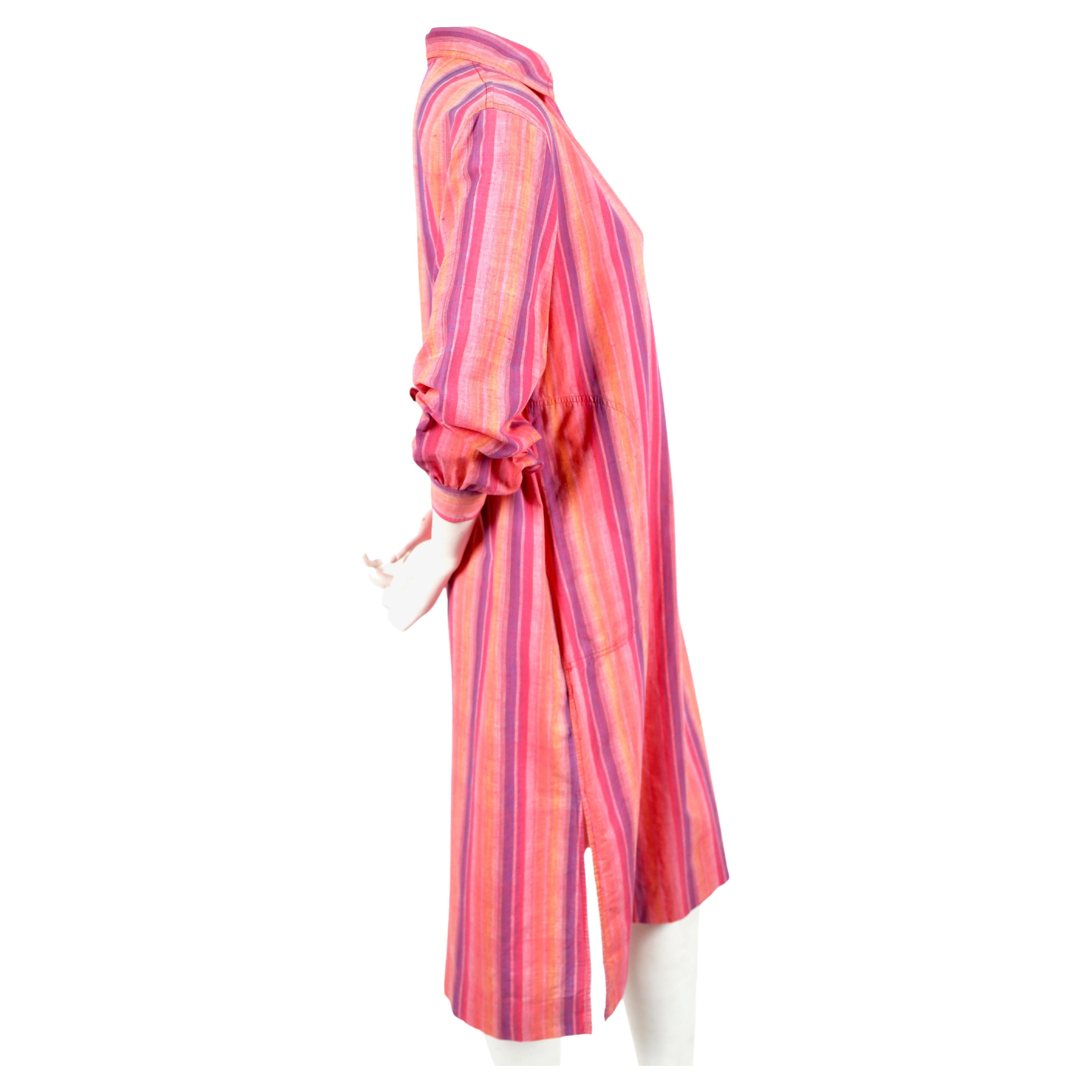 Brightly-colored, fuchsia, orange and purple striped cotton dress designed by Yves Saint Laurent dating to the 1970's. French size 40. Approximate measurements: shoulders 16.75