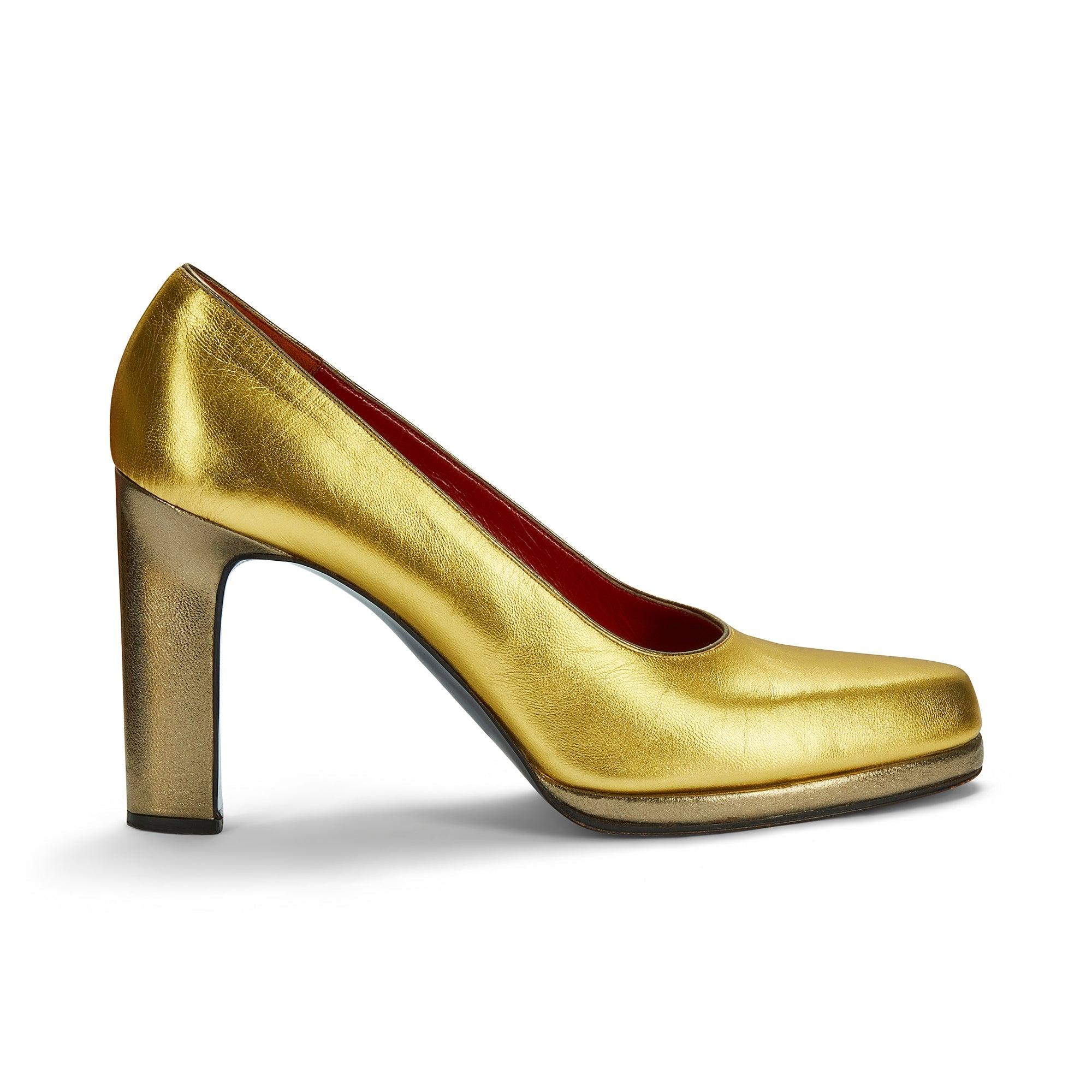 These striking Yves Saint Laurent block heeled shoes were designed in the late 1970s to early 1980s - the height of the disco period.  Crafted from polished gold leather and accented with silver leather at the heel and along the sole.  The insides