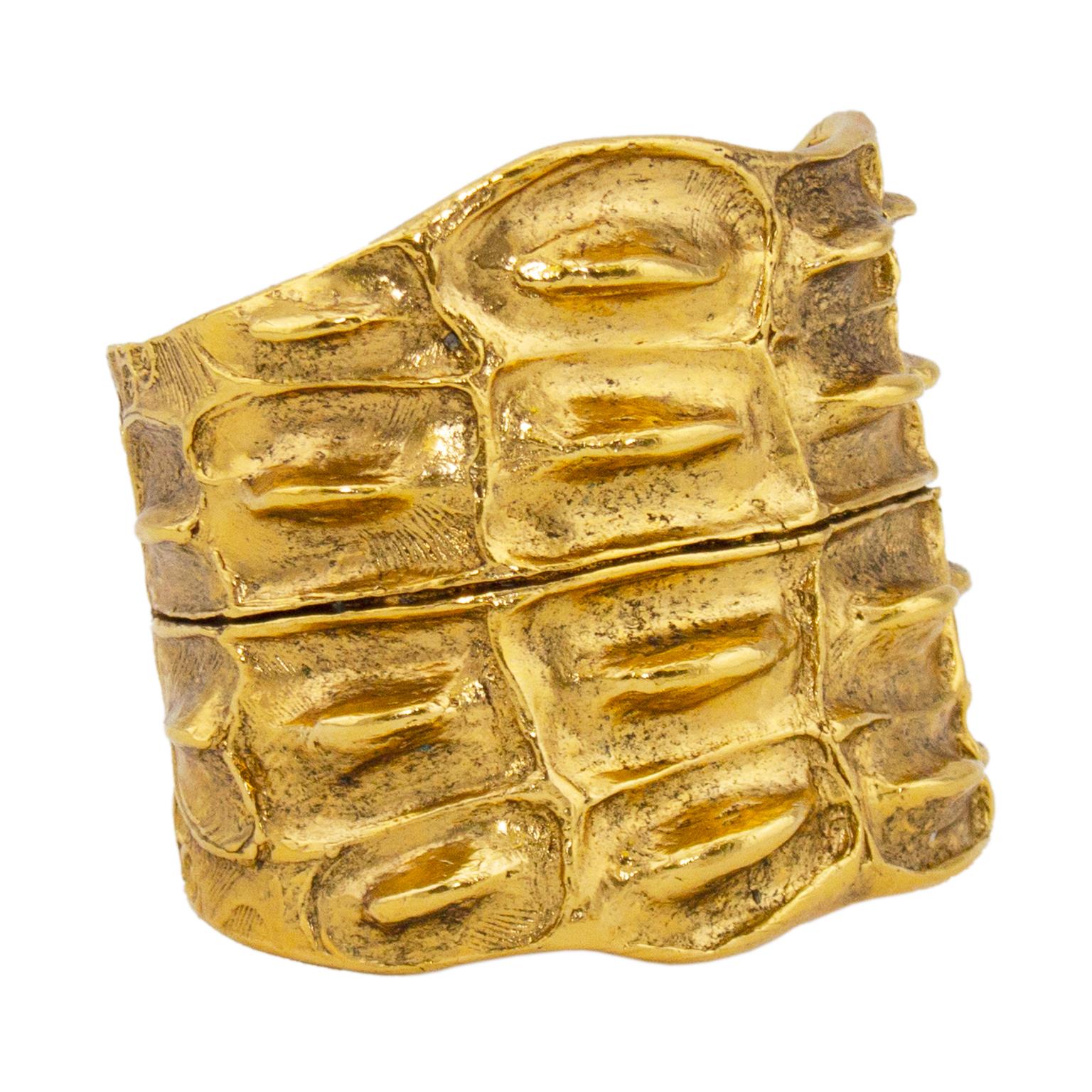 1970s Yves Saint Laurent large gold tone statement cuff. Metal is molded to look and feel like alligator skin. Abstract and asymmetrical, giving it a very natural look. Metal is slightly malleable so it can be opened a little bit to get on wrist and