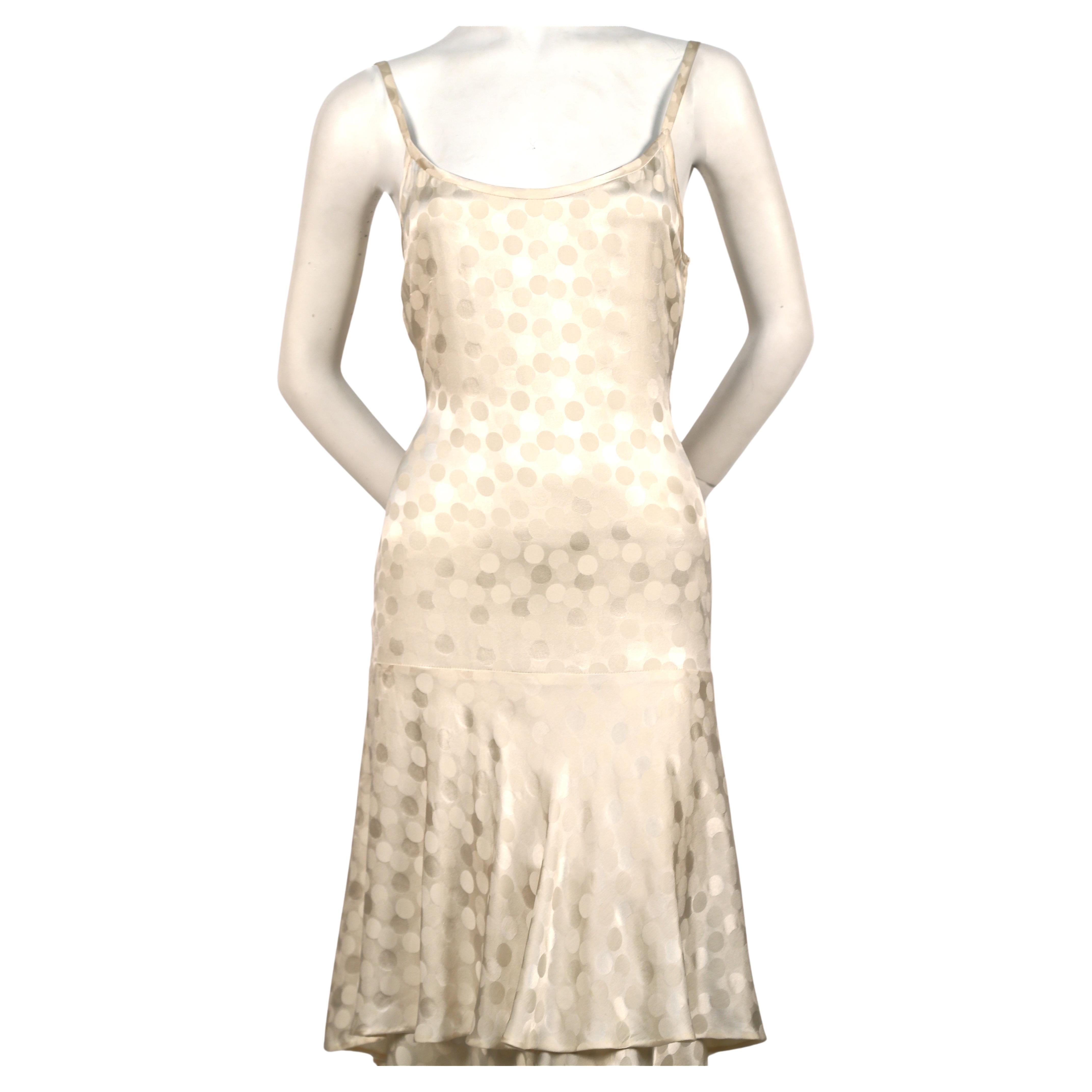 Very rare, stunning haute couture dress made of cream silk damask with subtle overlapping dot weave and tiered high/low hemline designed by Yves Saint Laurent dating to the 1970's. Dress would be great as a Wedding gown. Color is a light cream with