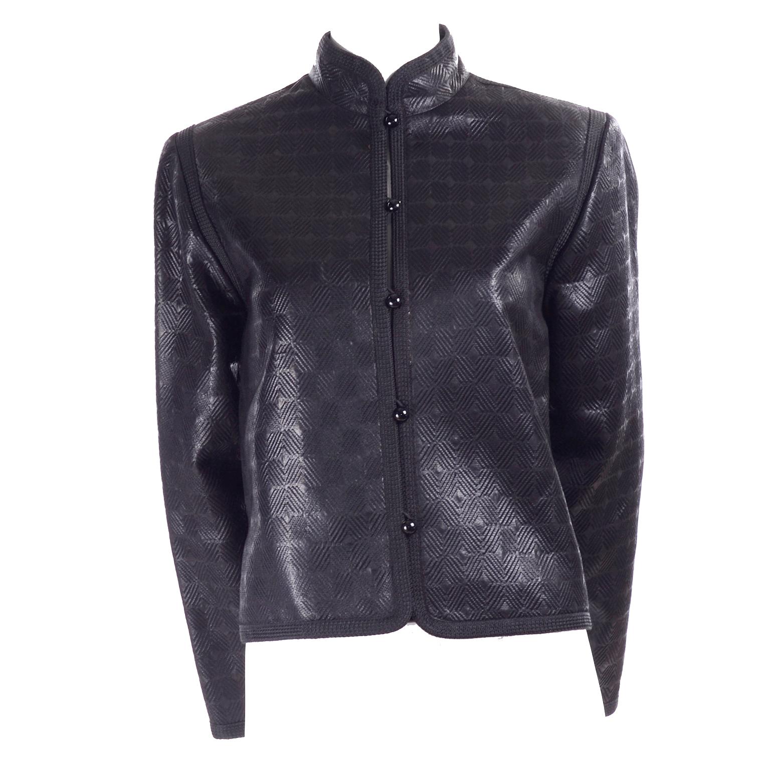 This is a rare Yves Saint Laurent vintage black jacket from the 1970's. It has a textured, quilted abstract graphic design in a structured cotton with a satin sheen, a mandarin collar and wide sleeves.Inspired by Russian bohemians and peasants, this