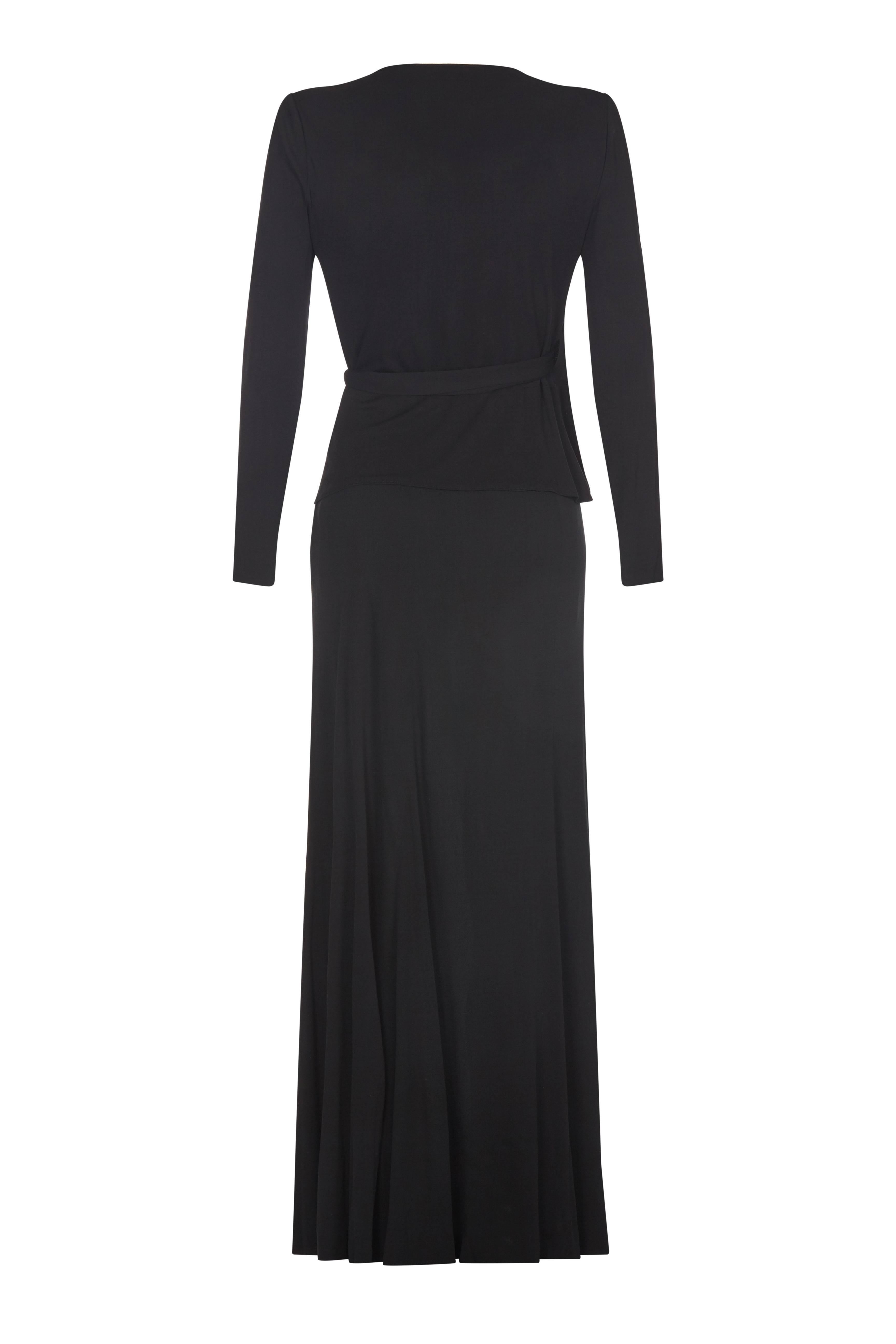 This elegant Yves Saint Laurent Circa 1974 black silk jersey two piece suit would lend itself effortlessly to both formal occasion wear and to evening wear. The simple lines create a classic silhouette whilst the generous silk jersey fabric has a