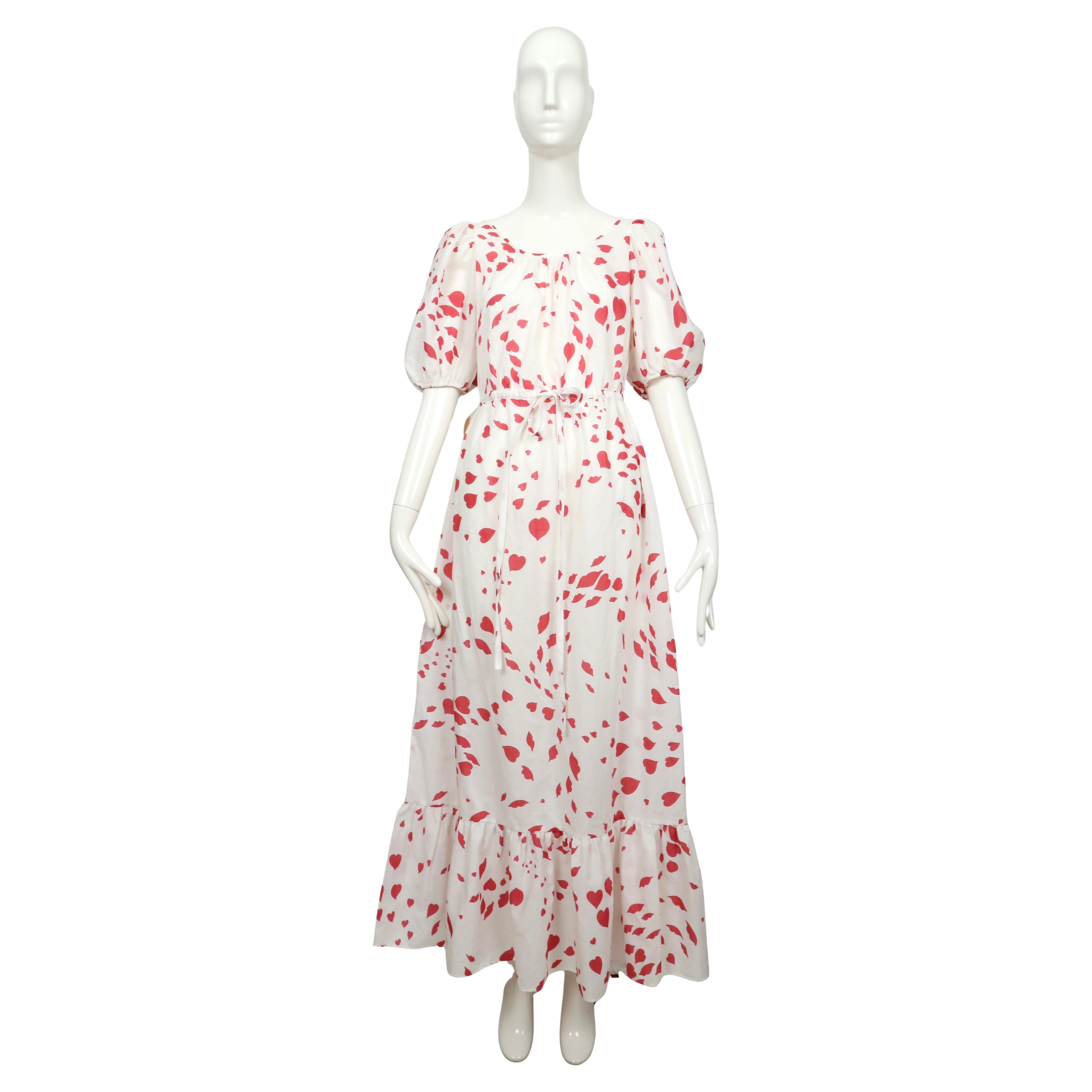 Fuchsia-red and white lip and heart print lounge dress from  Yves Saint Laurent dating to the 1970's. Labeled a French size 36/38.  Approximate measurements: shoulders 14