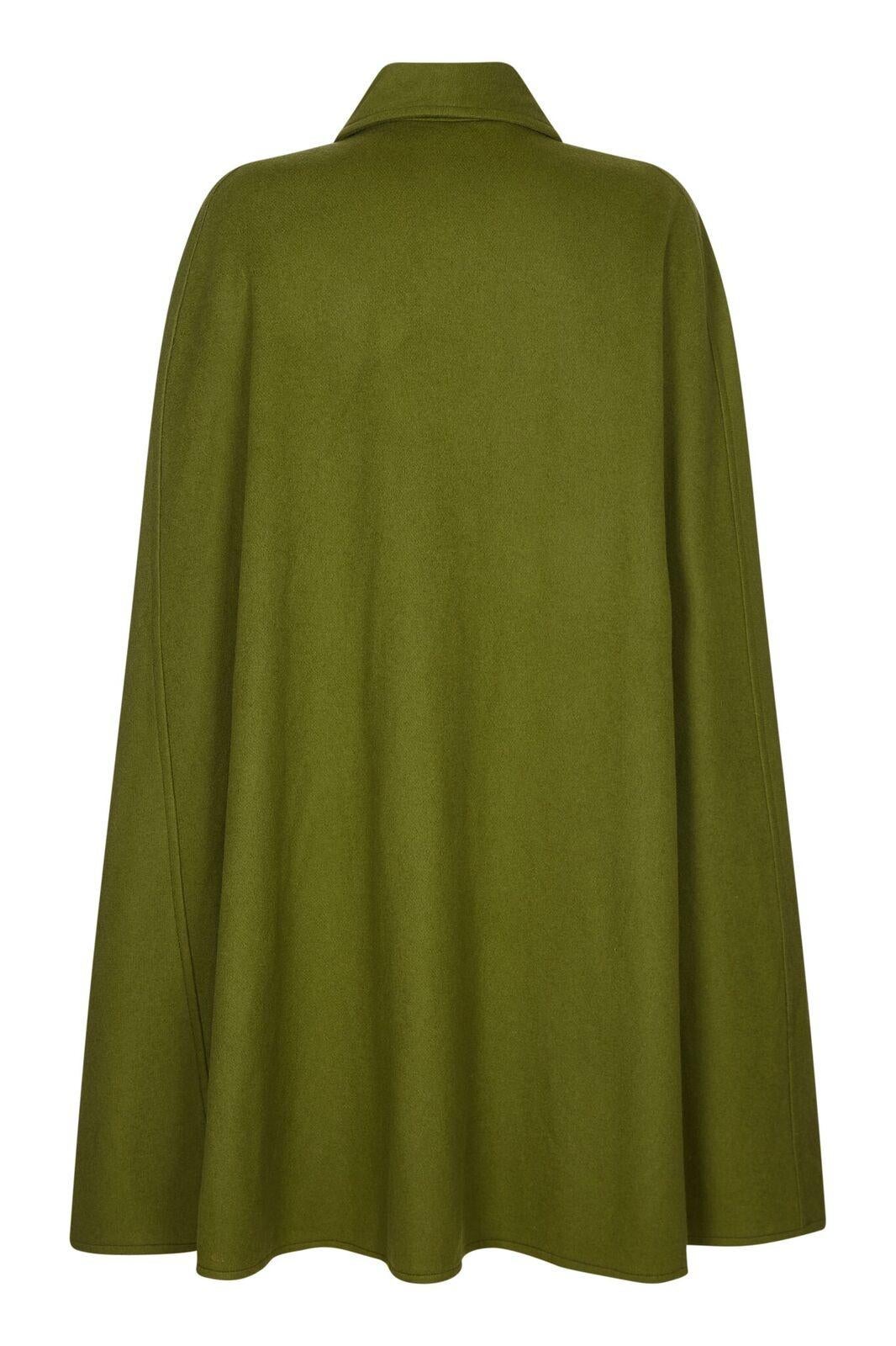 This magnificent Yves Saint Laurent woollen cape could be from the extolled 1976-77 Russian collection and is of exceptional quality. The pure wool fabric in soft moss green falls easily over the shoulders and finishes at the mid calf. There is a