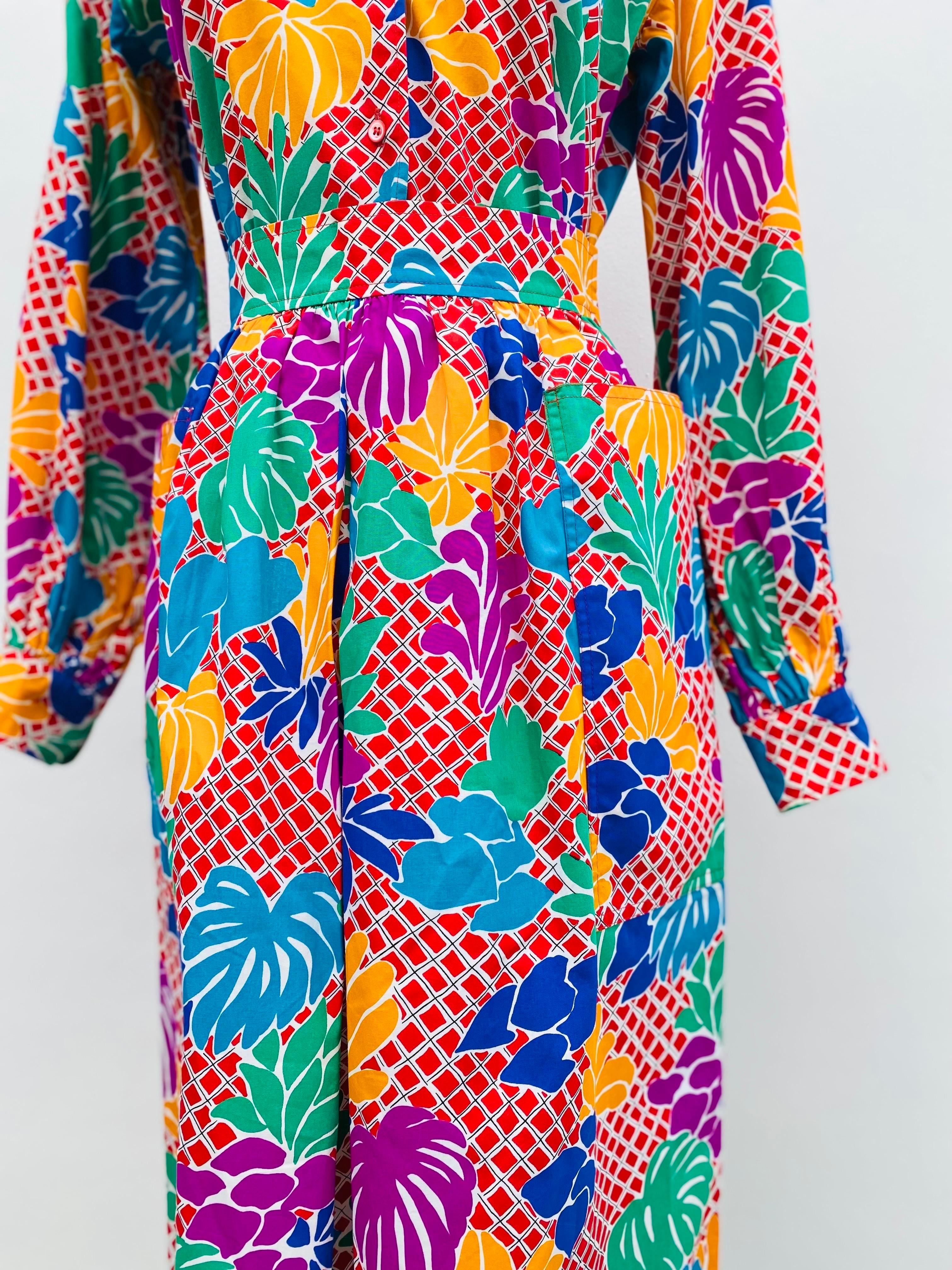 1970s Yves Saint Laurent YSL set of button down shirt and skirt in a bright pop art floral print on crisp cotton. Collared and button down shirt with a zip and clasp close on the midi length skirt. Excellent condition.  Listed size FR36 and best on