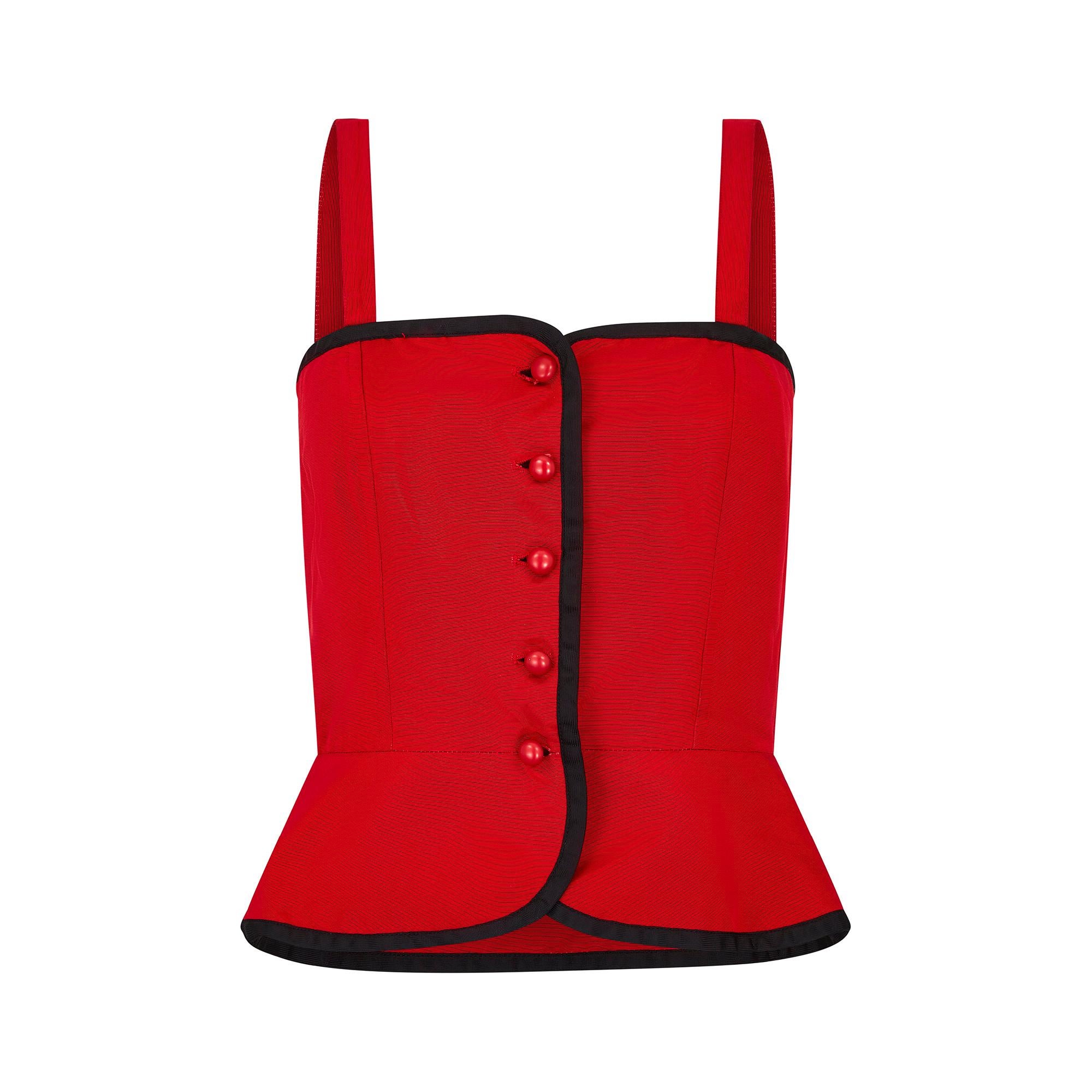 Original 1970s faille corset top by Yves Saint Laurent, in a pillar box red colour with contrasting black trim. The design is fitted throughout the bodice and waist, with a slight flare at the hem to create a beautiful nipped in silhouette. The