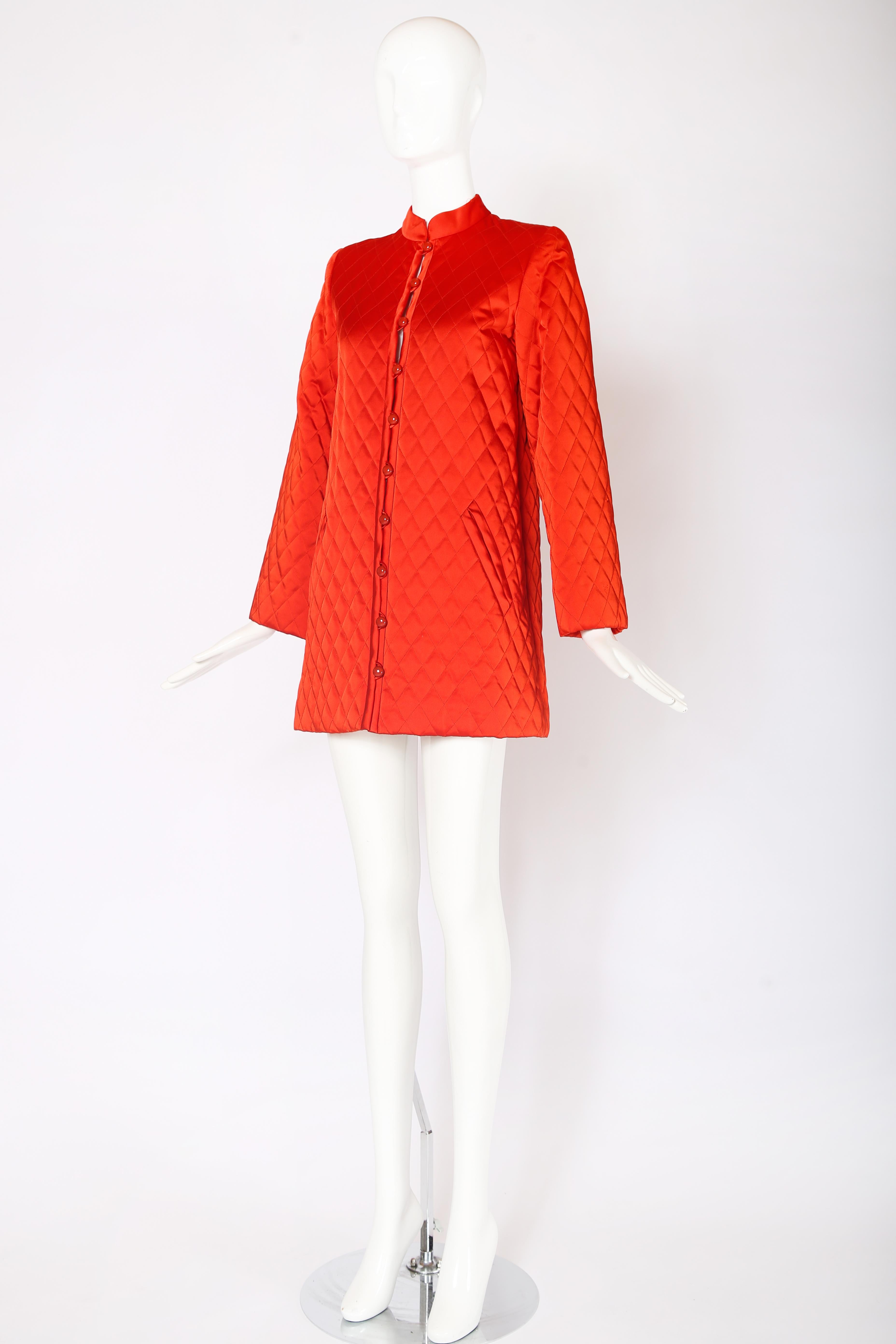 1970's Yves Saint Laurent vermillion colored quilted jacket w/a satin sheen. Features frontal slash pockets and shiny domed orange button loop closures down center front. In excellent condition. Size 38, 100% Rayon. Made in France.