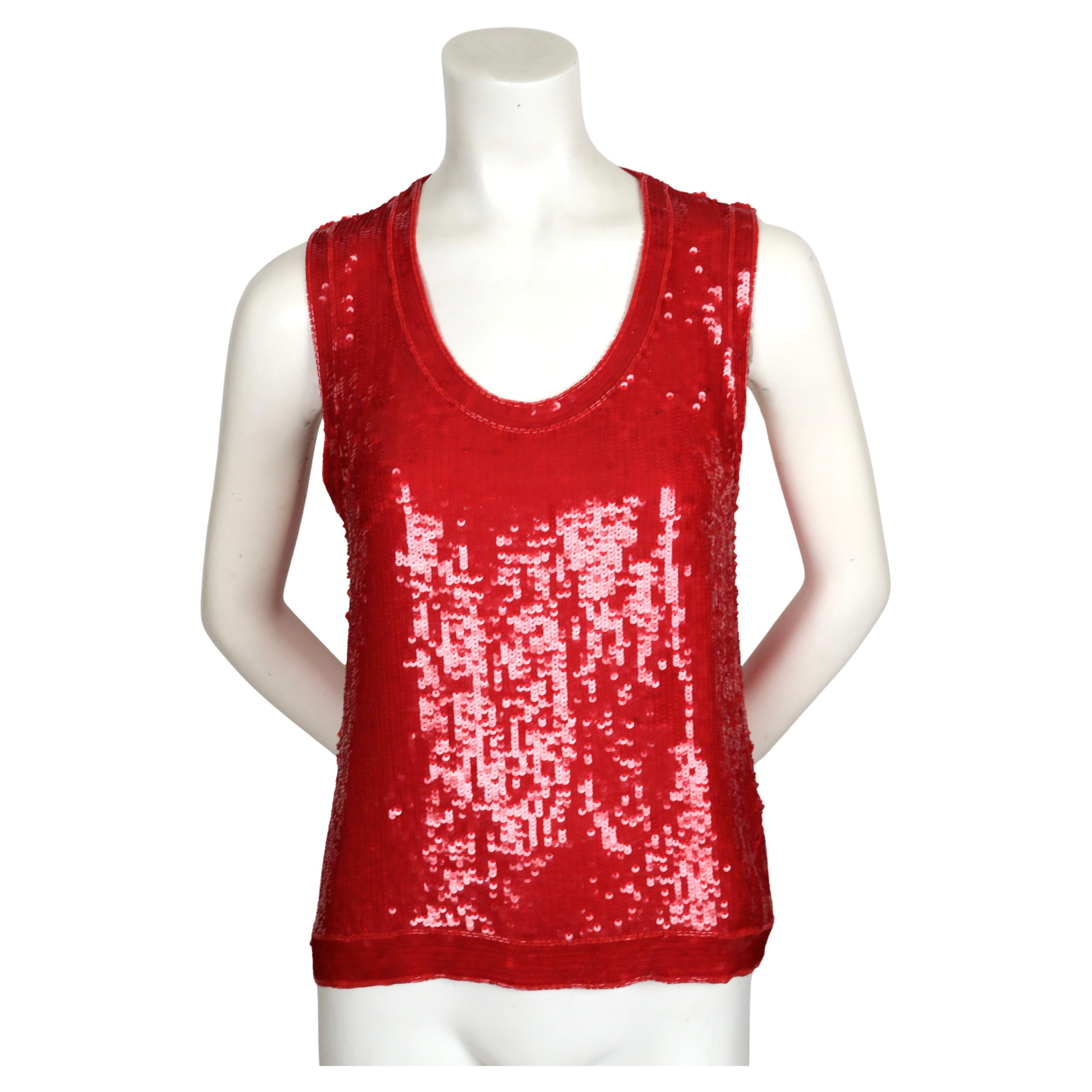 Vivid, red sequined tank top with bugle bead trim designed by Yves Saint Laurent dating to the late 1970's. Labeled a French size L however this best fits a modern S or M. Approximate measurements: shoulder 14
