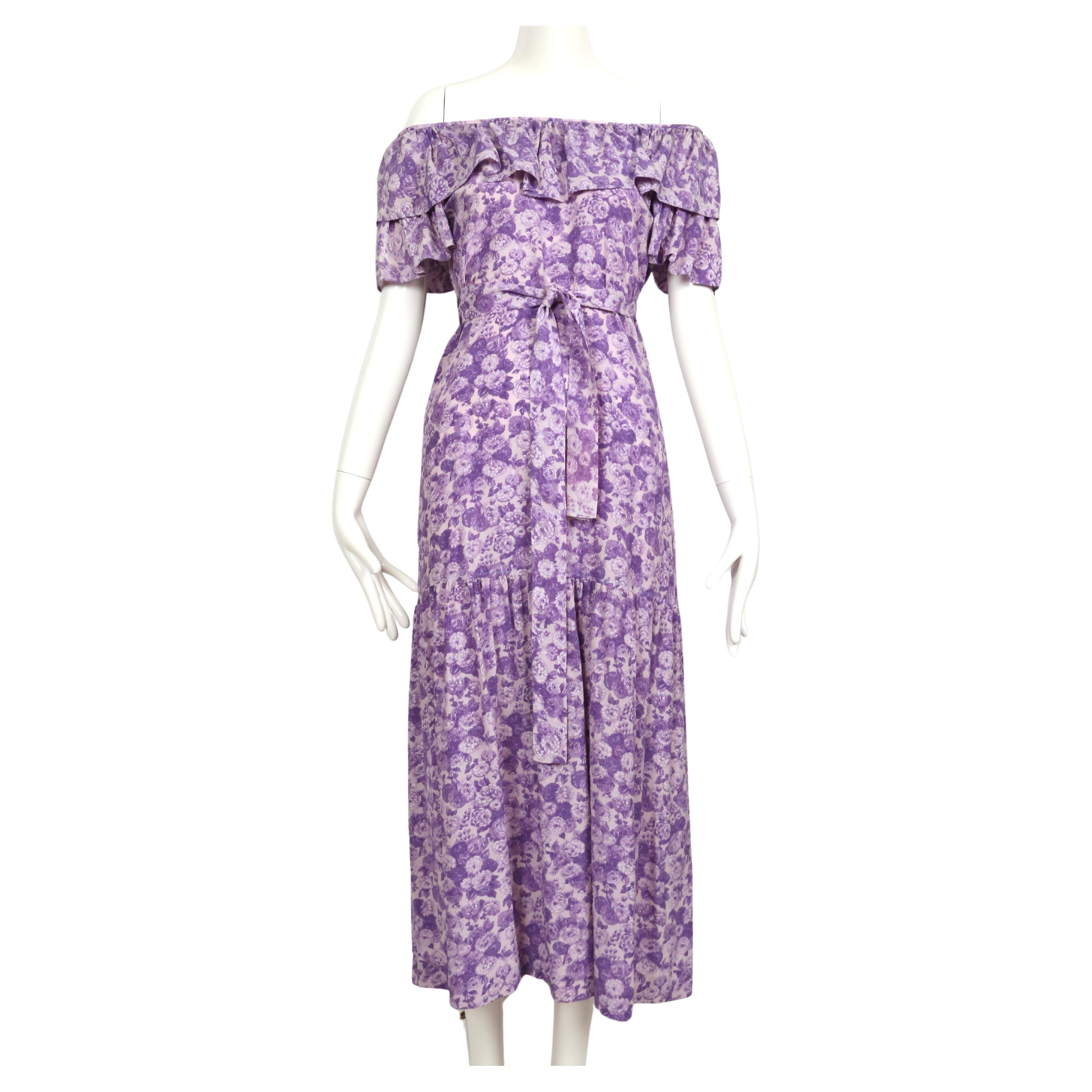 Purple, floral-printed, silk dress with long waist tie from Yves Saint Laurent dating to spring of 1976 as seen on the runway. Labeled a French size 42 however this fits very small, especially if worn off the shoulders. Approximate measurements: up