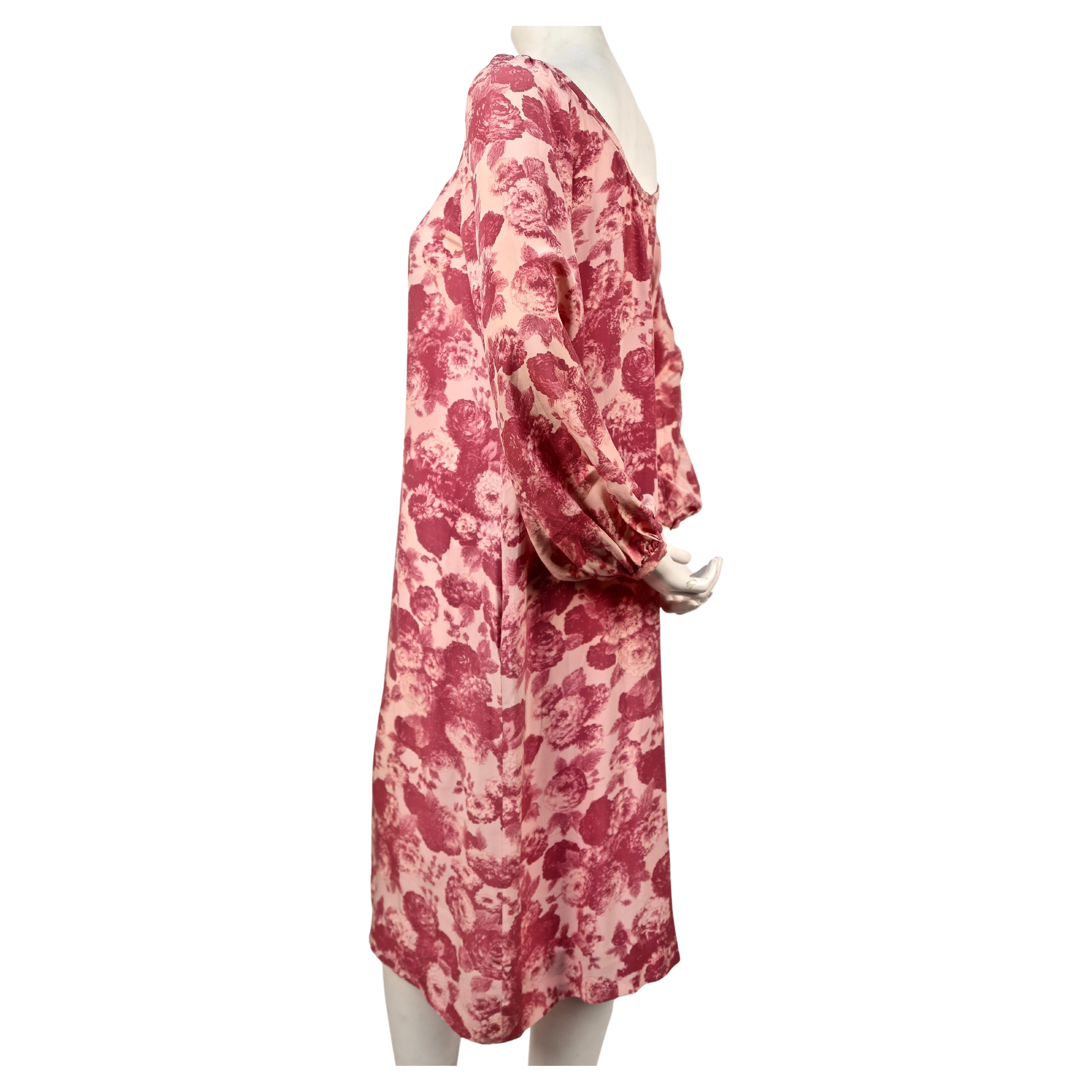 Pink, rose floral-printed, silk dress with open neckline designed by Yves Saint Laurent dating to the 1970's. Fits a US size 4-6. Approximate measurements: bust 38