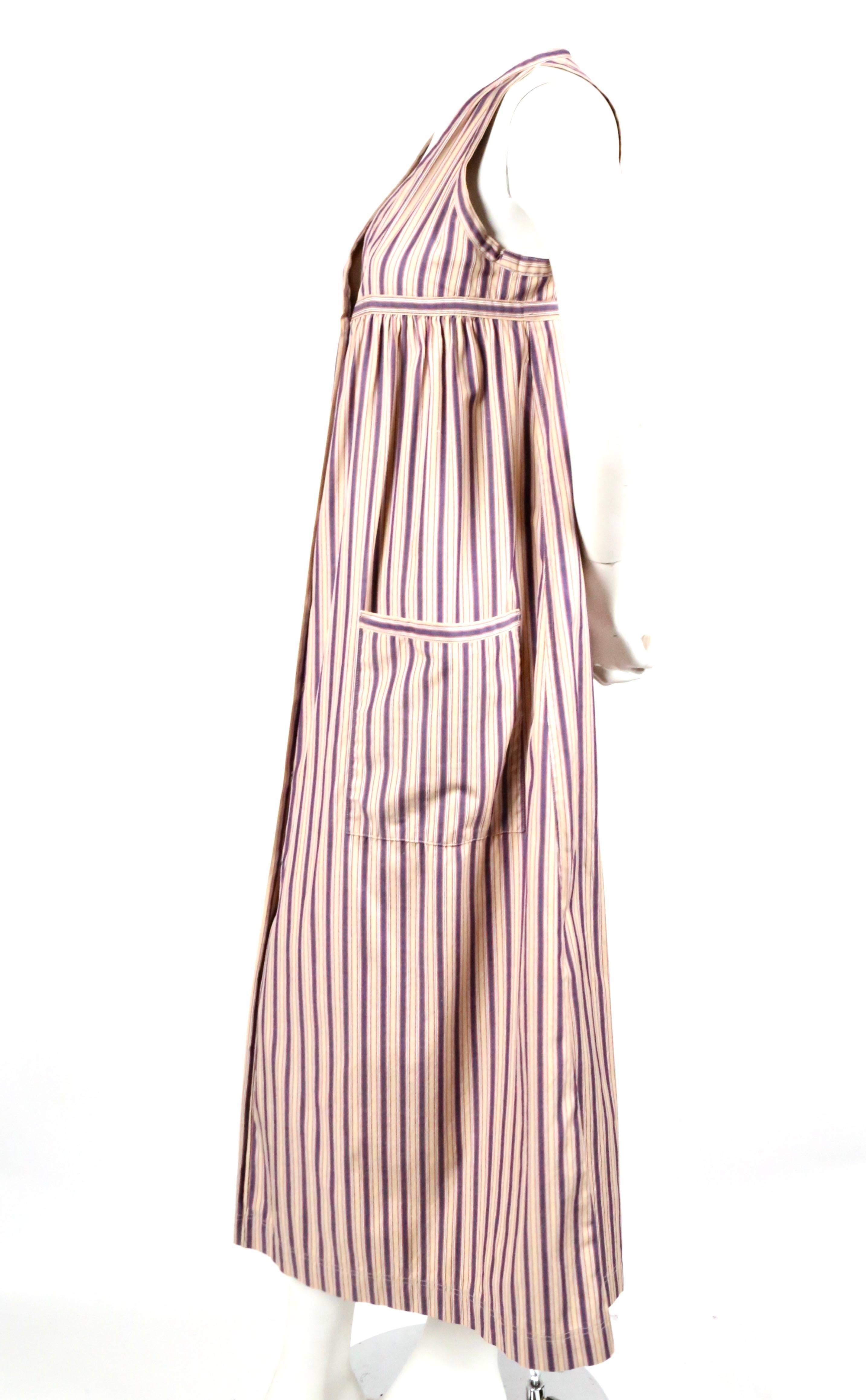 Striped cotton dress with patch pockets designed by Yves Saint Laurent dating to the 1970's. Labeled a French size 34 however the dress has been altered underarms so it best fits a US 2-4. Approximate measurements: bust 34