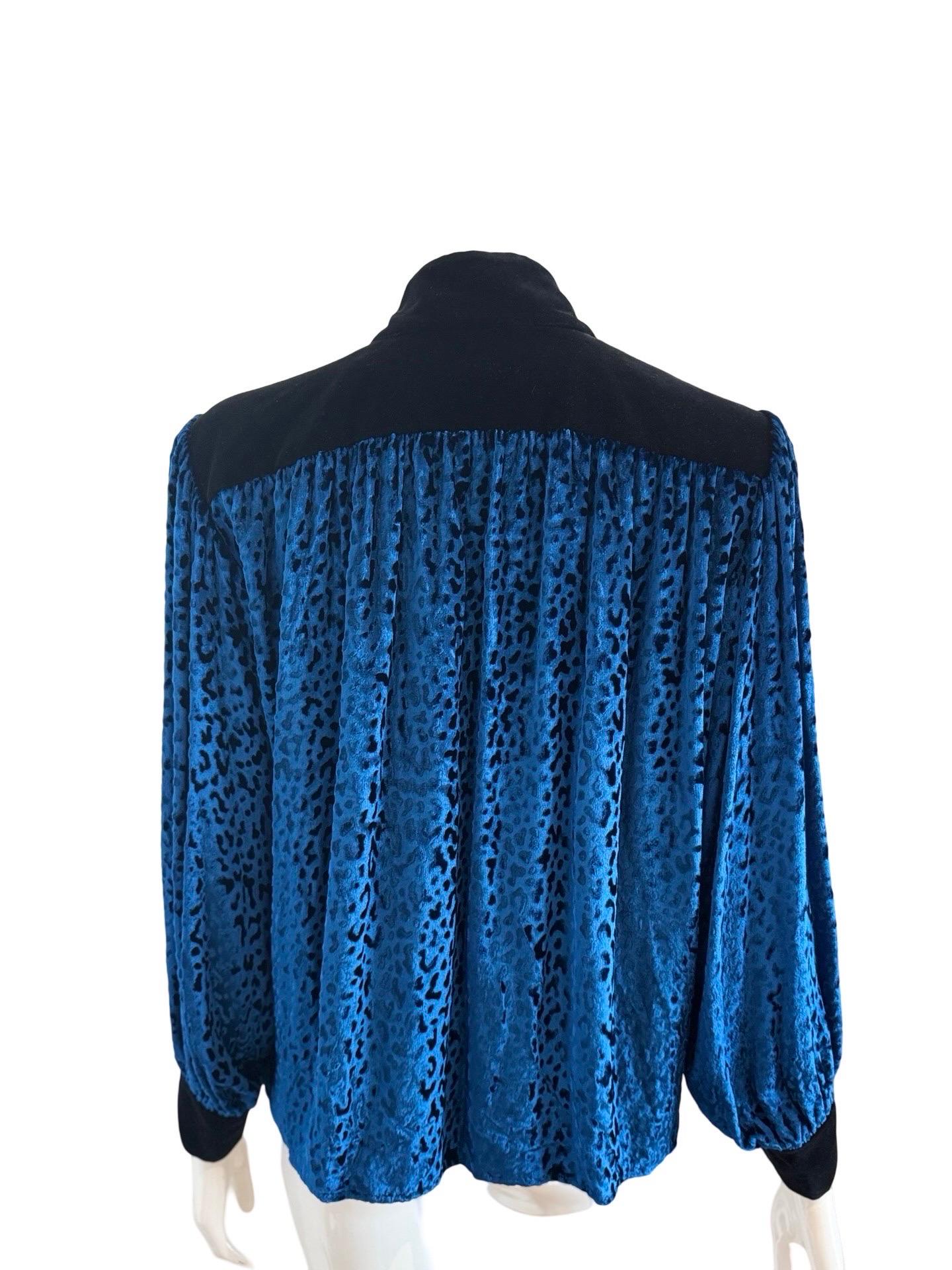 70s perfection from this YSL velvet tunic top in a stunning eye popping blue color with jacquard leopard print. Black velvet contrast on the shoulders, cuffs and chest.  Rope ties with black tassels. Labelled a size FR42 and would work on a variety