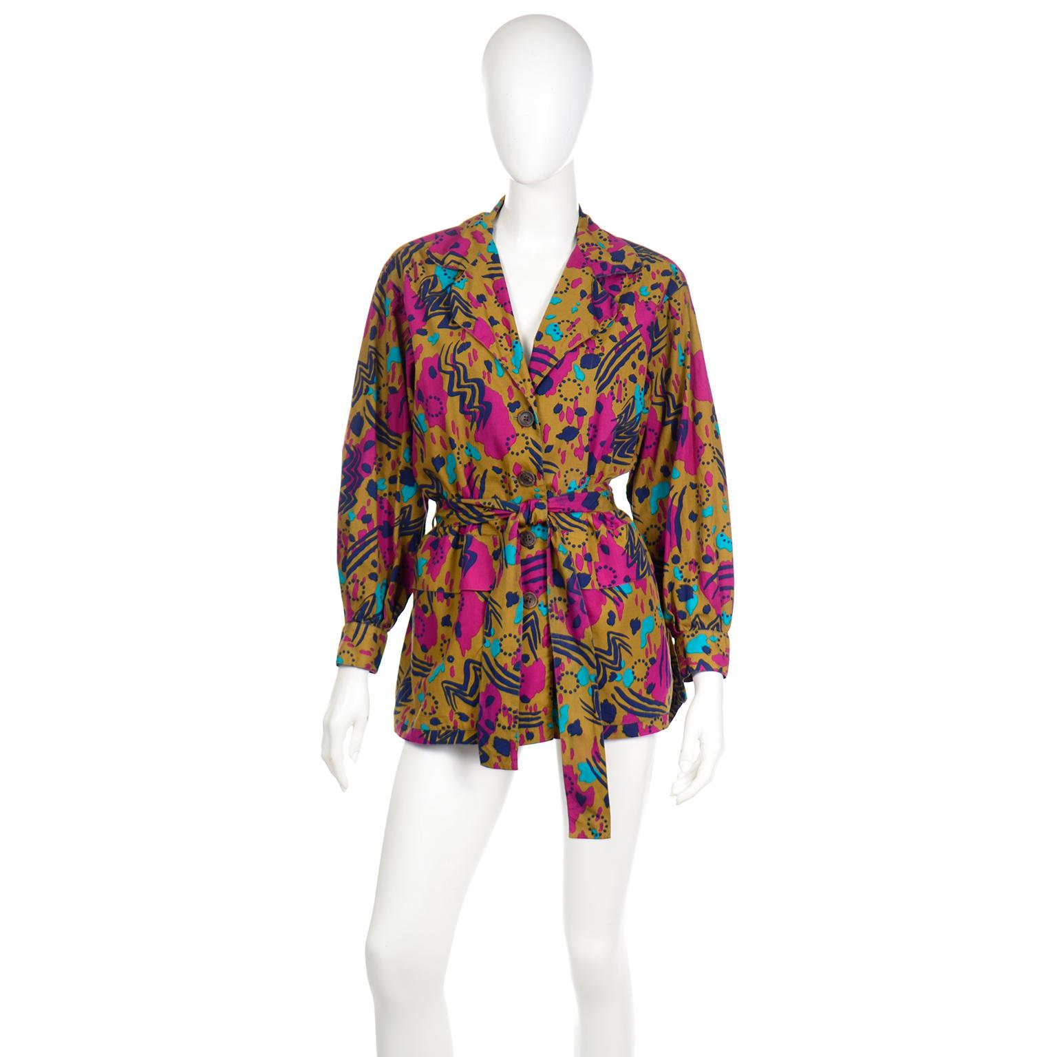 This fabulous vintage YSL  jacket style shirt with front patch pockets  is a perfect example of Saint Laurent's talent! The top is in an almost olive green but with a bit more of a yellow tinge to the hue, with an abstract magenta pink, turquoise