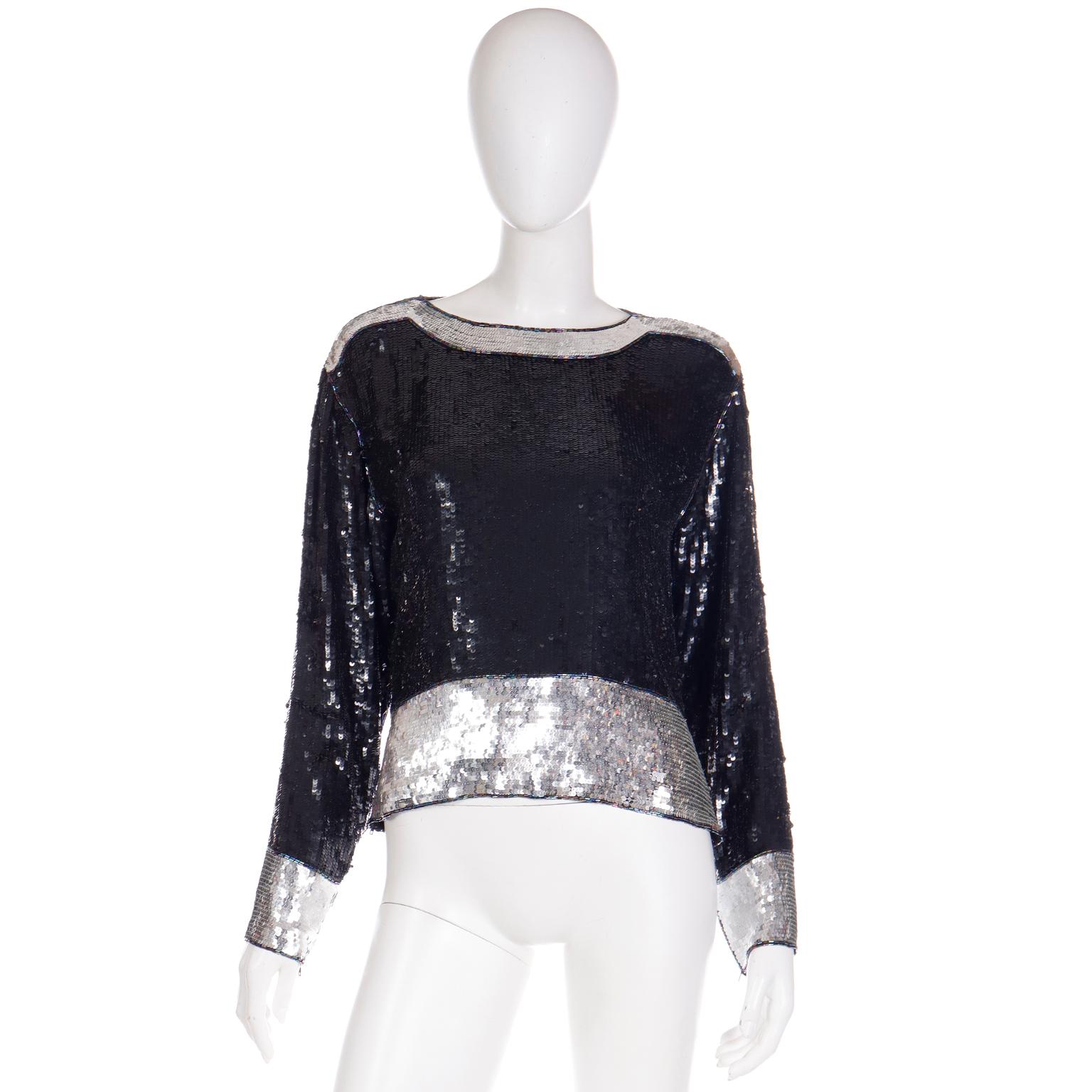 This is a fabulous vintage Yves Saint Laurent 1970's top made of 100% silk that is covered in black and silver sequins. The top has iridescent black bugle beads that trim the shoulders, neckline, cuffs and hemline. The body of the piece is black and