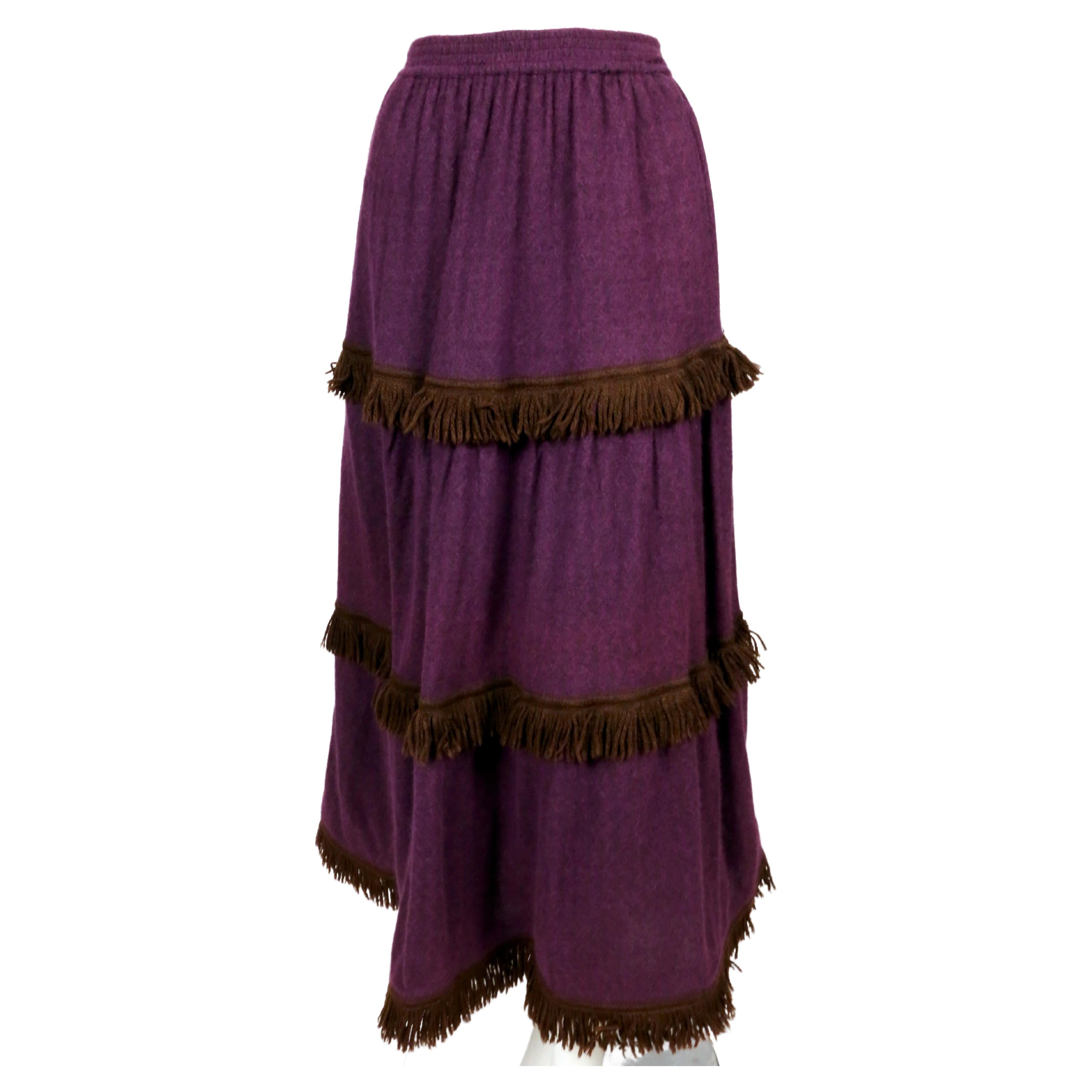 Very soft, rich purple wool skirt with brown fringed yarn trim designed by Yves Saint Laurent dating to the 1970's. No size is indicated however this was acquired with two other  identical skirts in other colors with the same measurements both