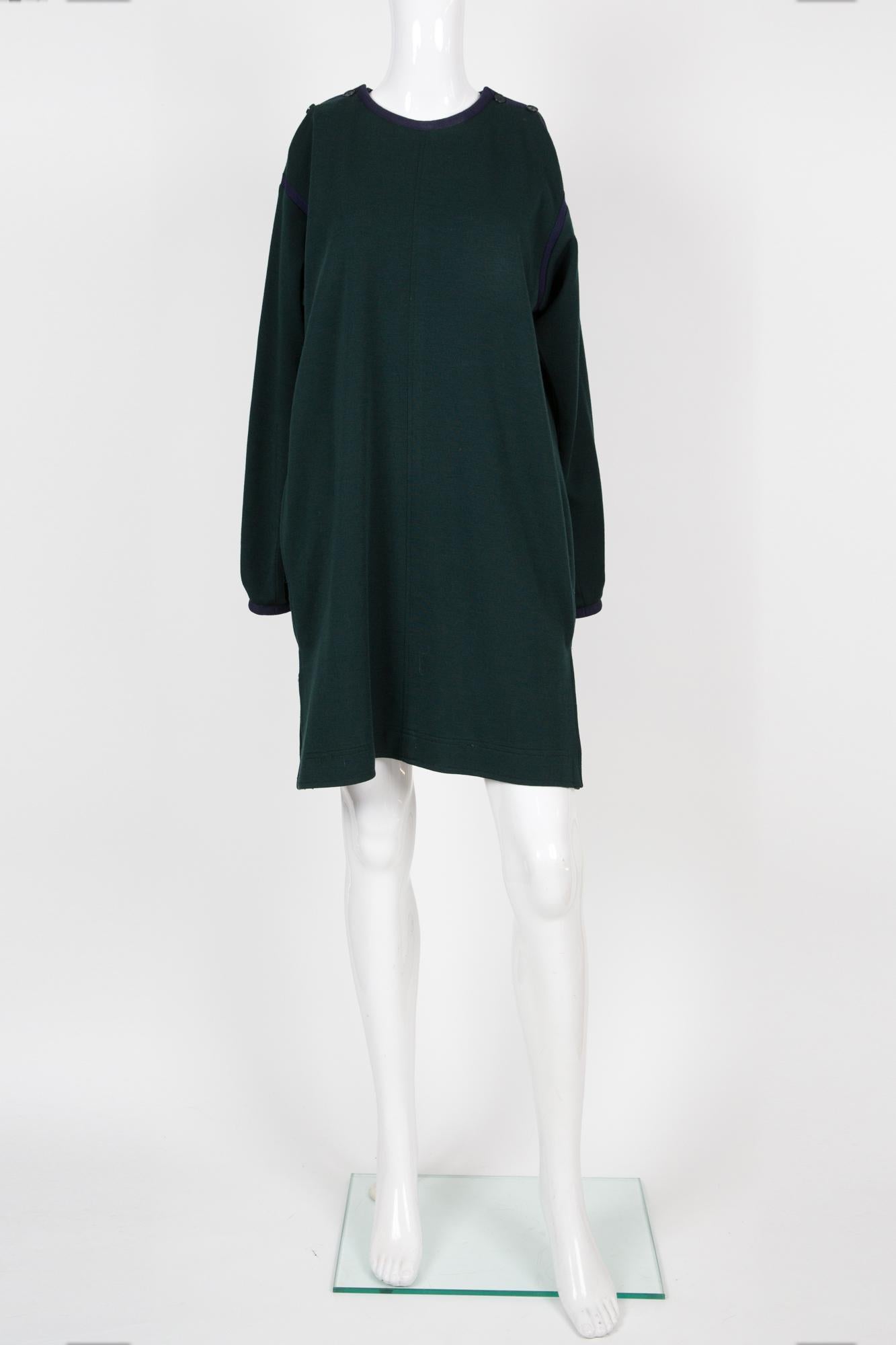 Yves Saint Laurent YSL green wool dress featuring a navy braided finishing at armholes, neck & cuffs, shoulder navy buttons, sides pockets and sides slits.
Circa 1970s
Composition: 100% wool
Estimated size 40fr/US8/UK12
Made in France. 
In good