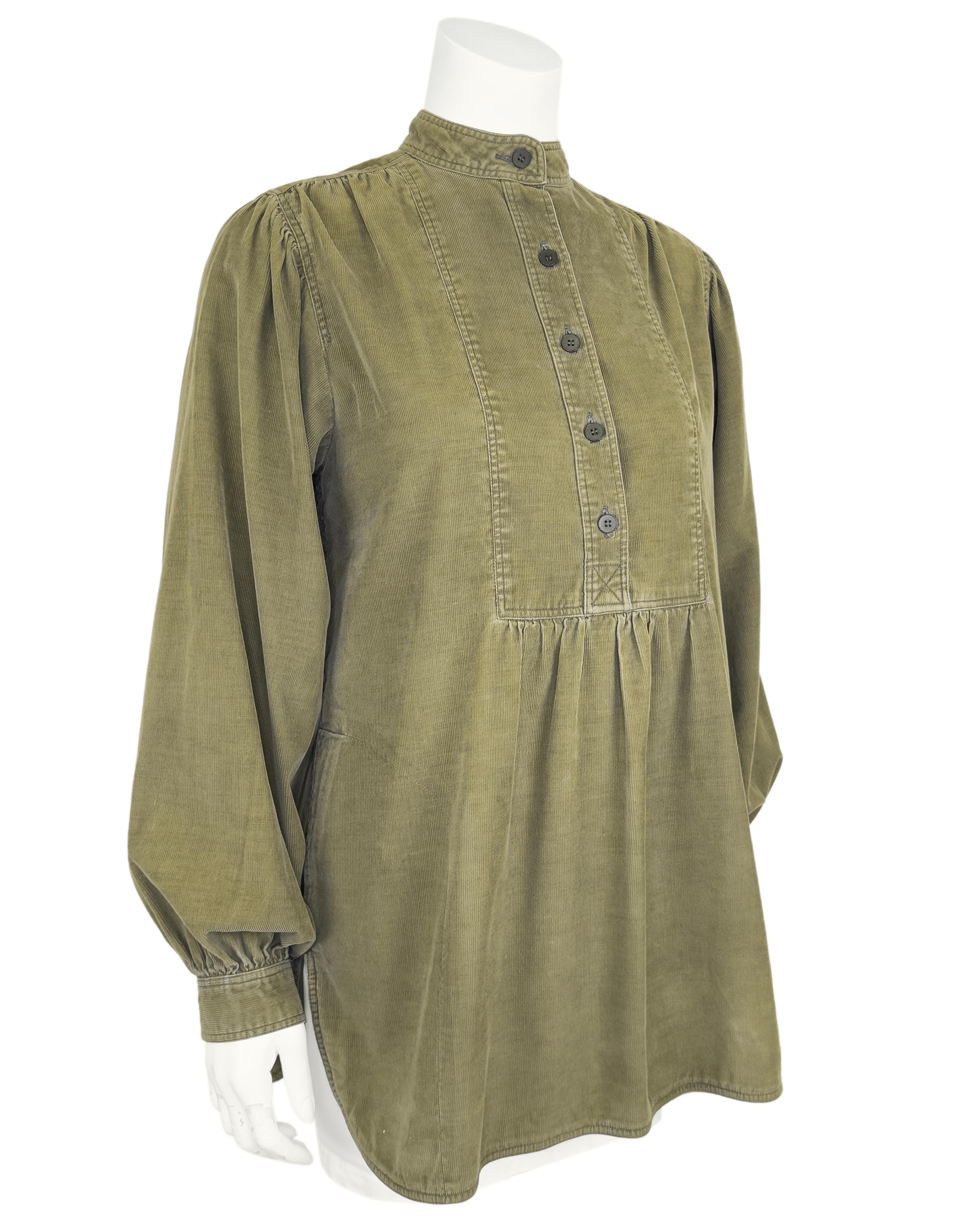 Yves Saint Laurent Rive Gauche olive green corduroy peasant style top from the 1970s. Mandarin collar with a rectangular seamed bib style and henley style buttons down the front. Slight ruching under the yoke creates a empire like fit and the top is